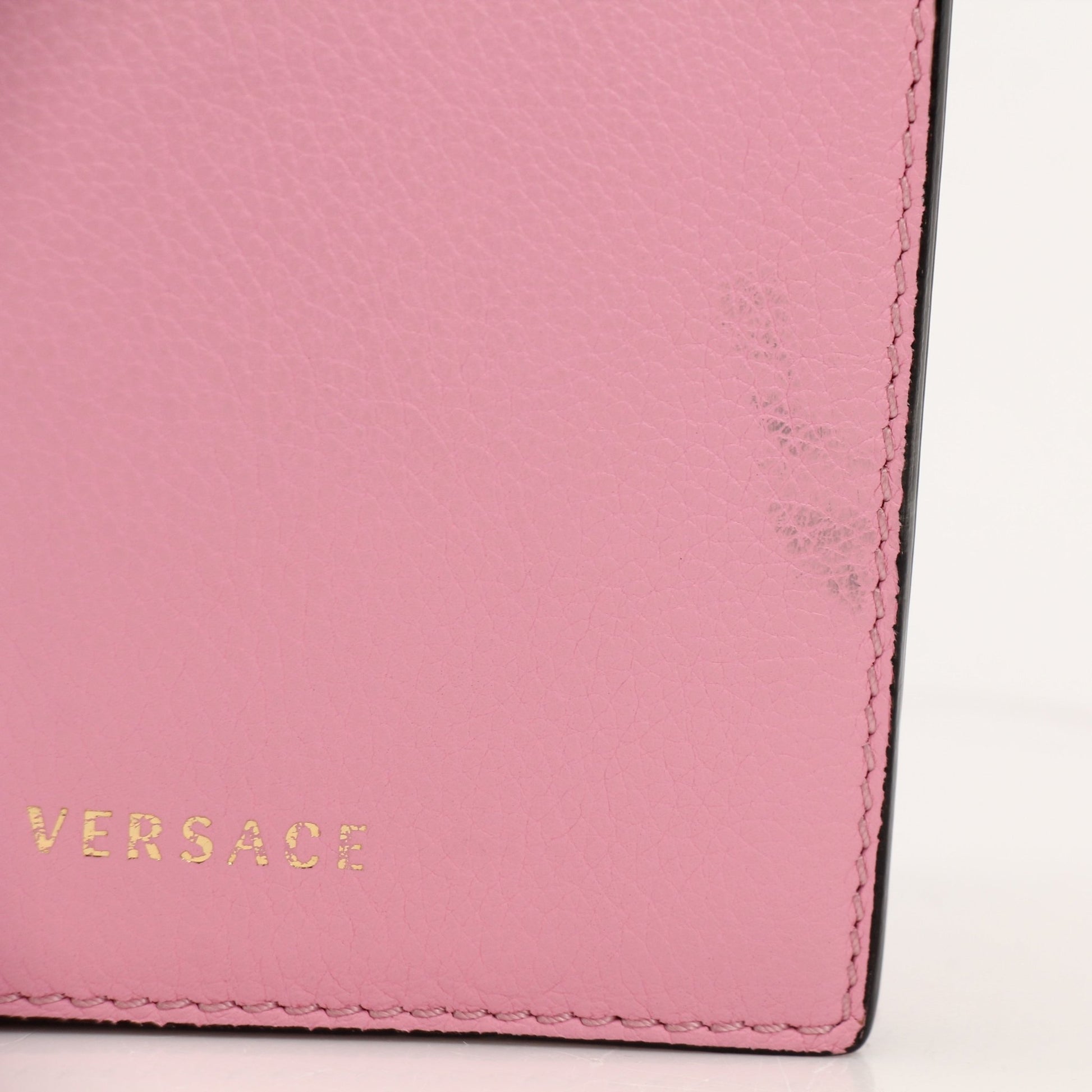 Gold & Beyond Versace La Medusa iPhone case handbag with Medusa detail and gold accents, designed for stylish phone protection.