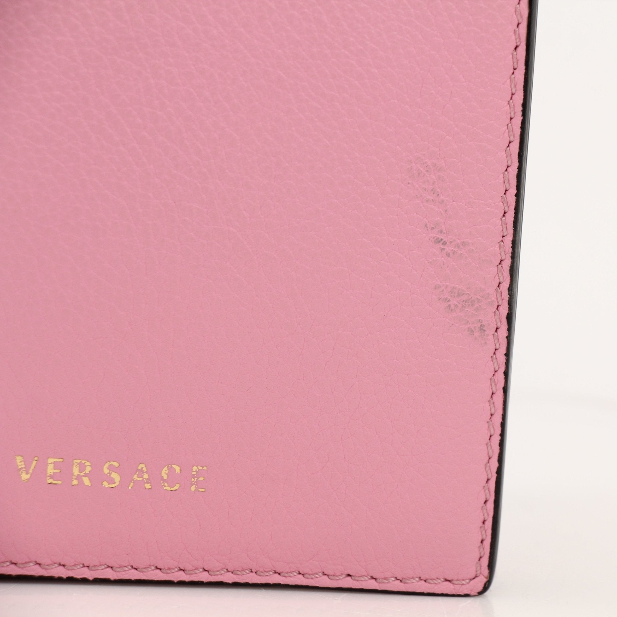 Gold & Beyond Versace La Medusa iPhone case handbag with Medusa detail and gold accents, designed for stylish phone protection.