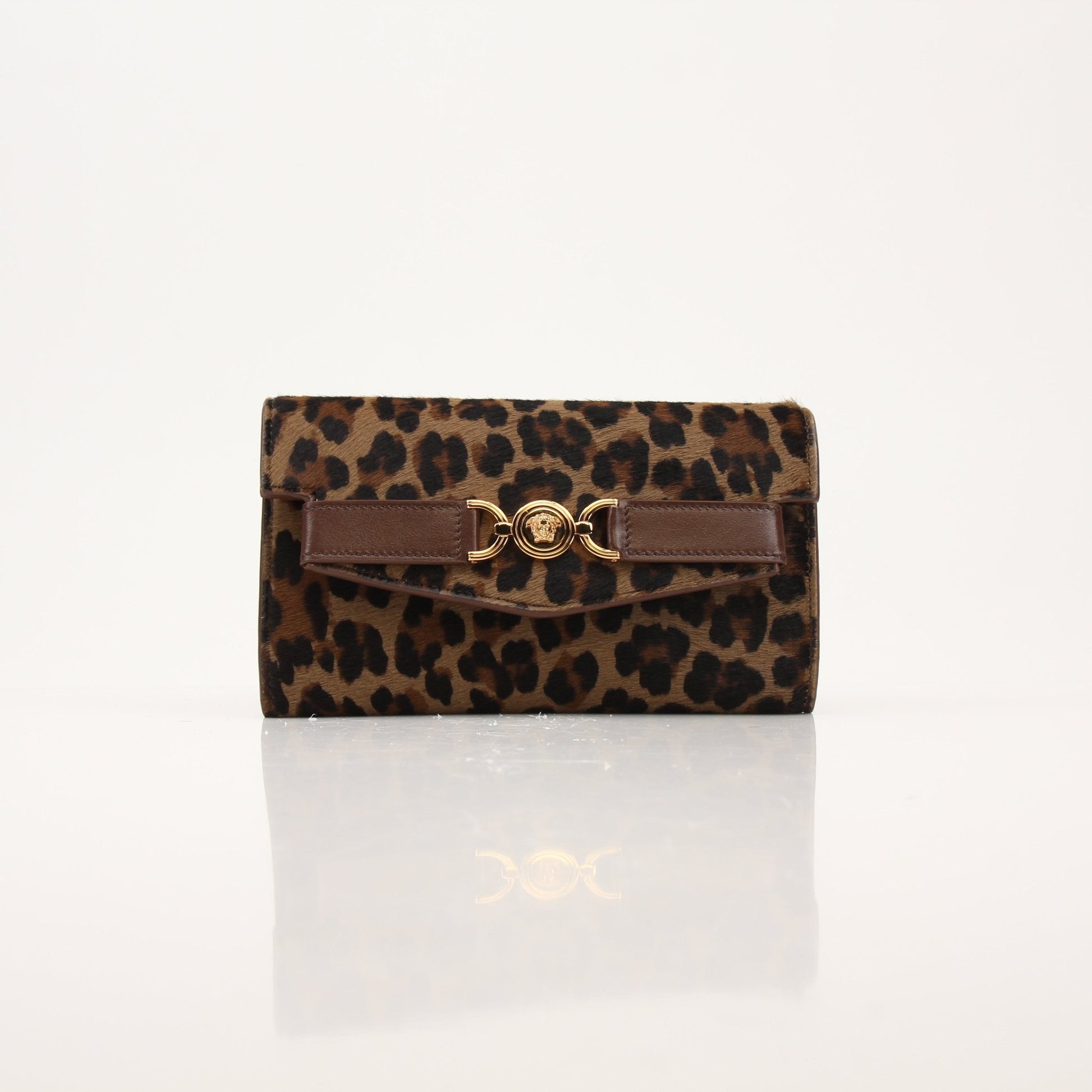 Gold & Beyond leopard print pony hair clutch handbag with sleek design and gold-tone hardware.