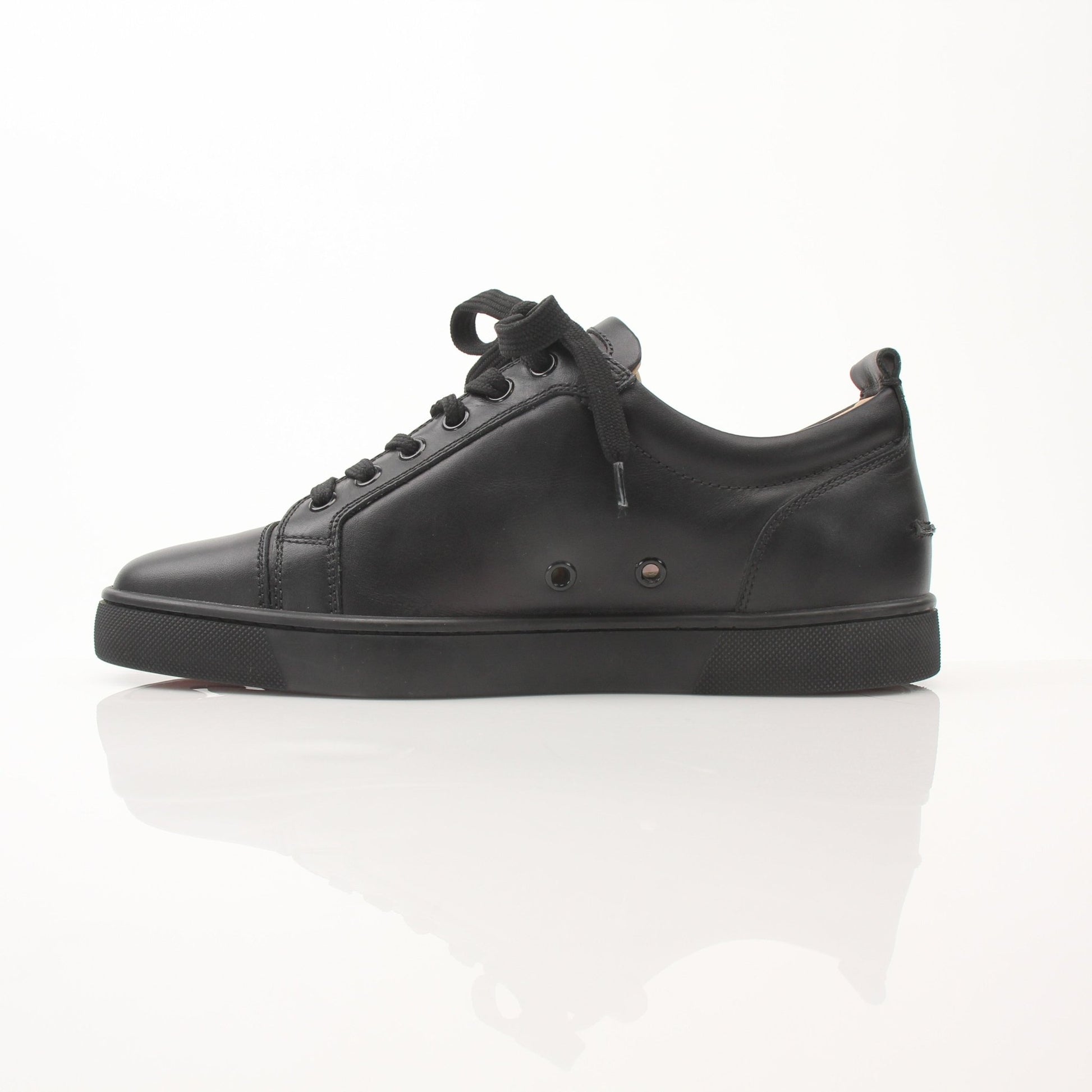 Christian Louboutin Louis Junior sneakers in black with red sole details, stylish shoes for men by Gold & Beyond.