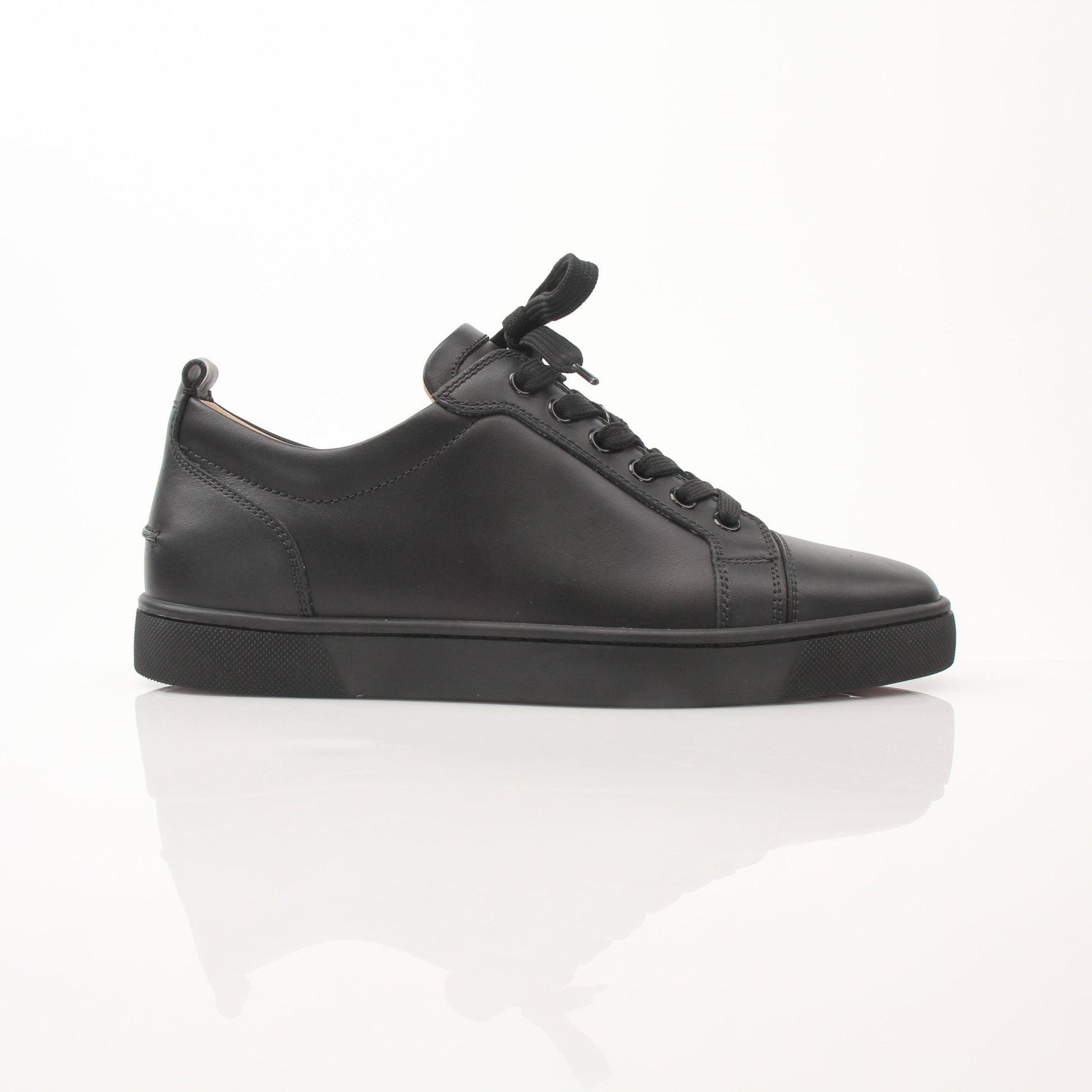 Christian Louboutin Louis Junior sneakers in black with signature red soles, showcasing stylish shoes from Gold & Beyond.