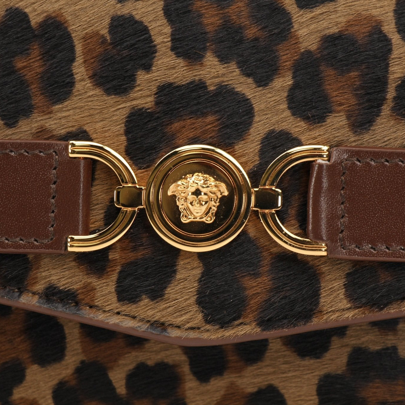 Gold & Beyond Versace Leopard Pony Hair Clutch handbag with gold accents and sleek design, perfect for evening wear.