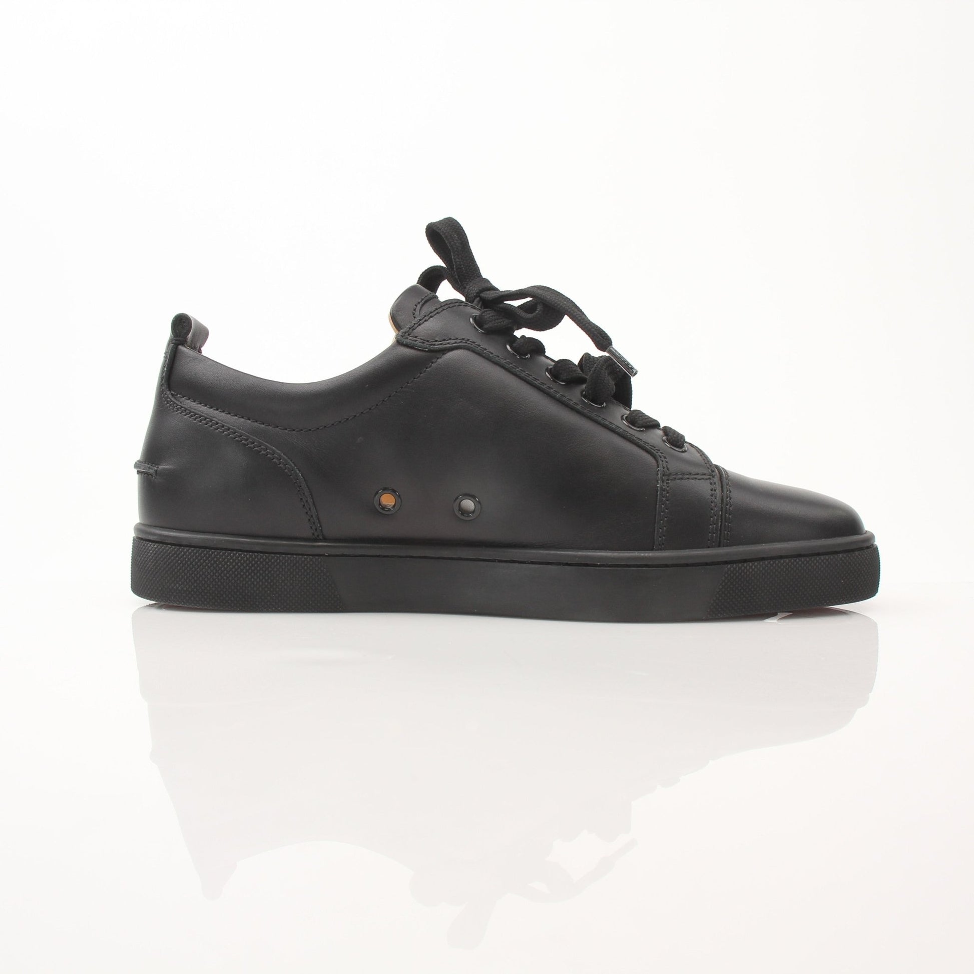 Christian Louboutin Louis Junior sneakers from Gold & Beyond featuring black shoes with signature red soles and stylish design.