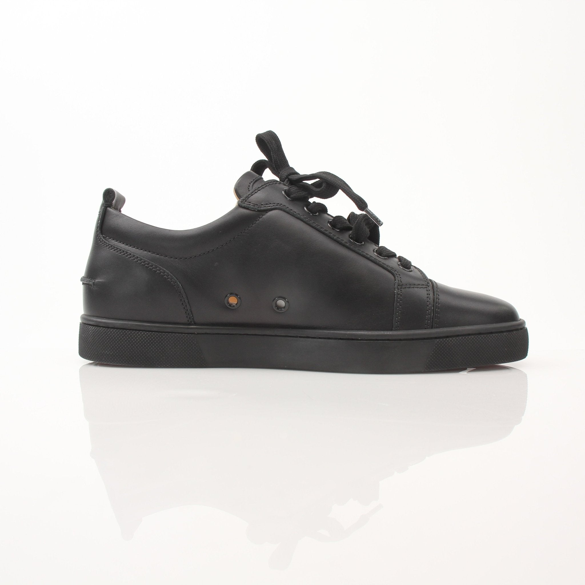 Christian Louboutin Louis Junior sneakers from Gold & Beyond featuring black shoes with signature red soles and stylish design.