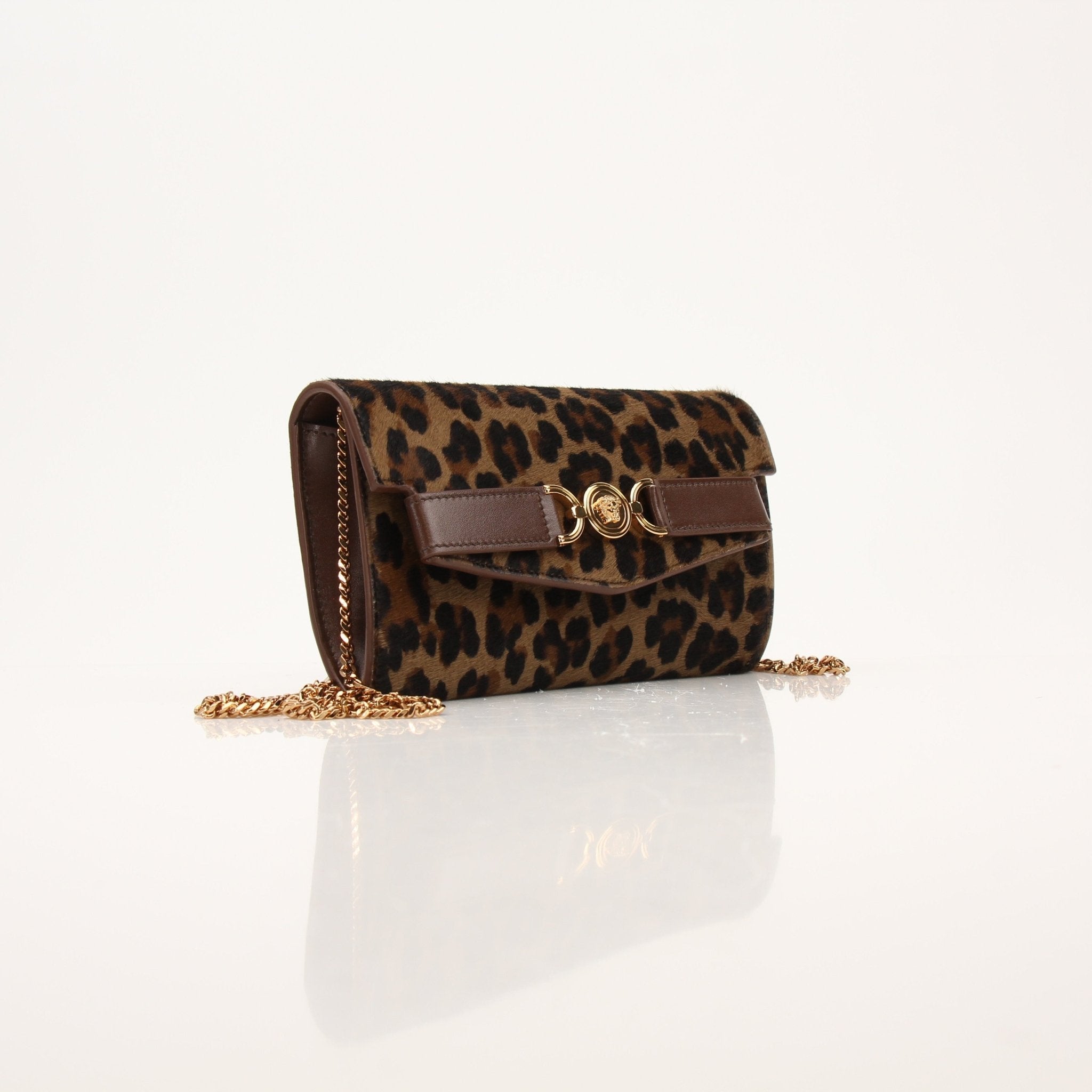 Gold & Beyond Versace Leopard Pony Hair Clutch handbag with gold accents and sleek design.