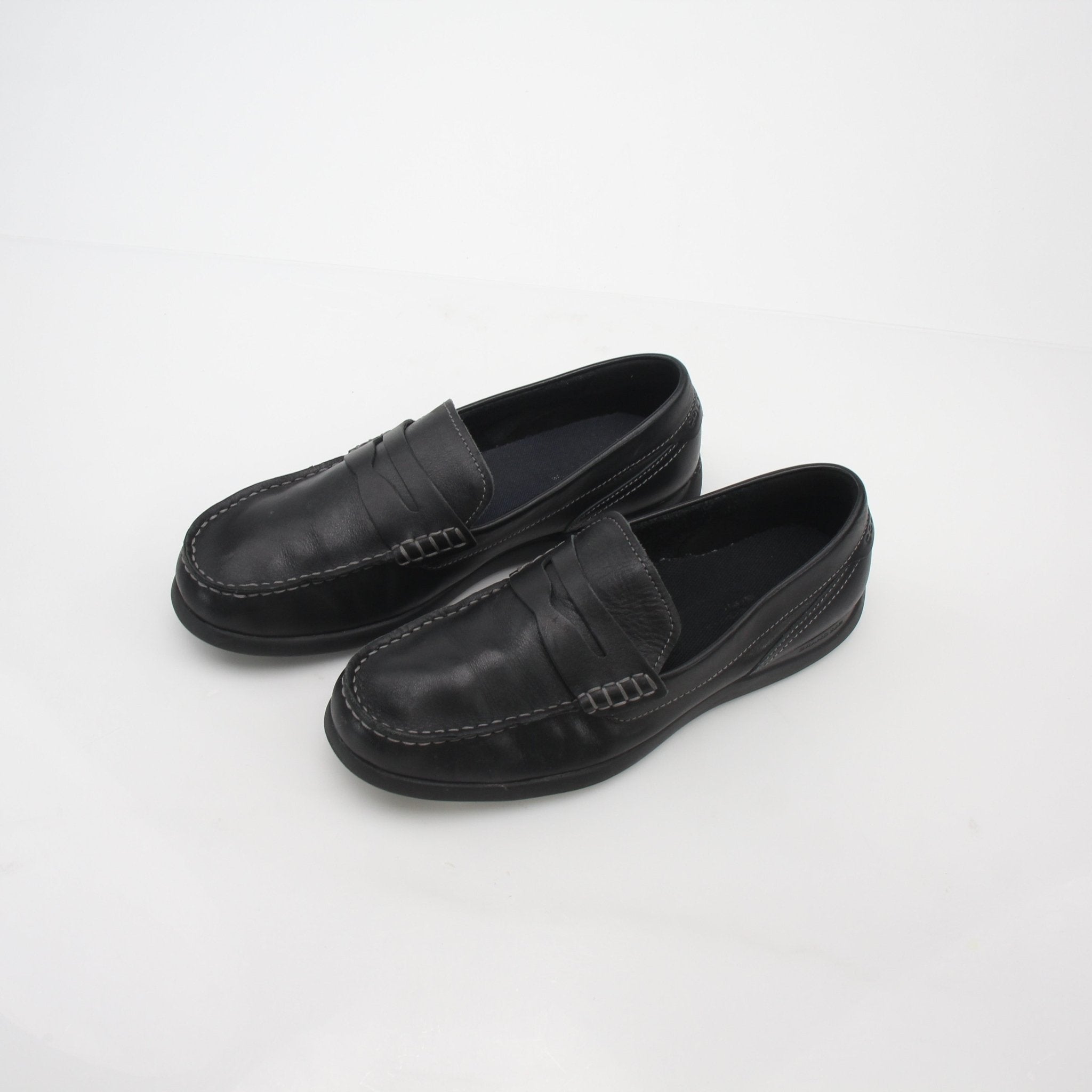 Black leather Cole Haan Grand Atlantic penny loafers, classic men's shoes with sleek design and slip-on style.