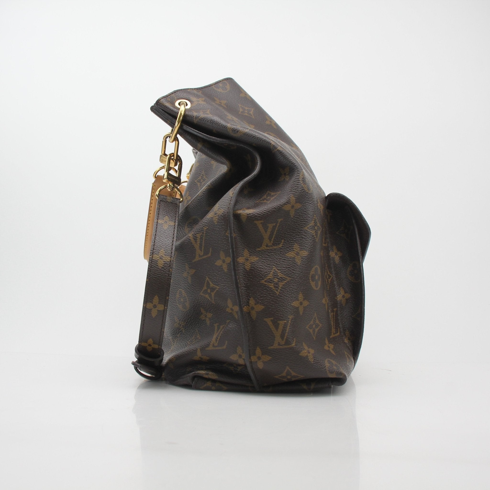 Louis Vuitton Monogram Metis Hobo Bag, gold hardware, leather strap, and monogram canvas, stylish handbag on a neutral background.