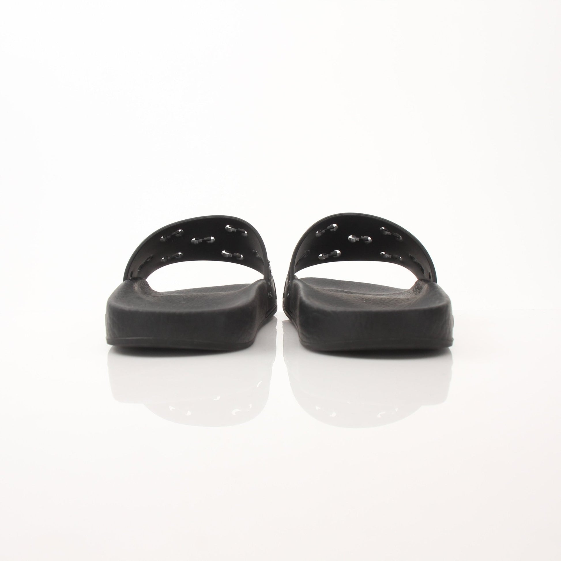 Gucci Pursuit Slides by Gold & Beyond, stylish slip-on shoes with a sleek design, showcased on a neutral background.