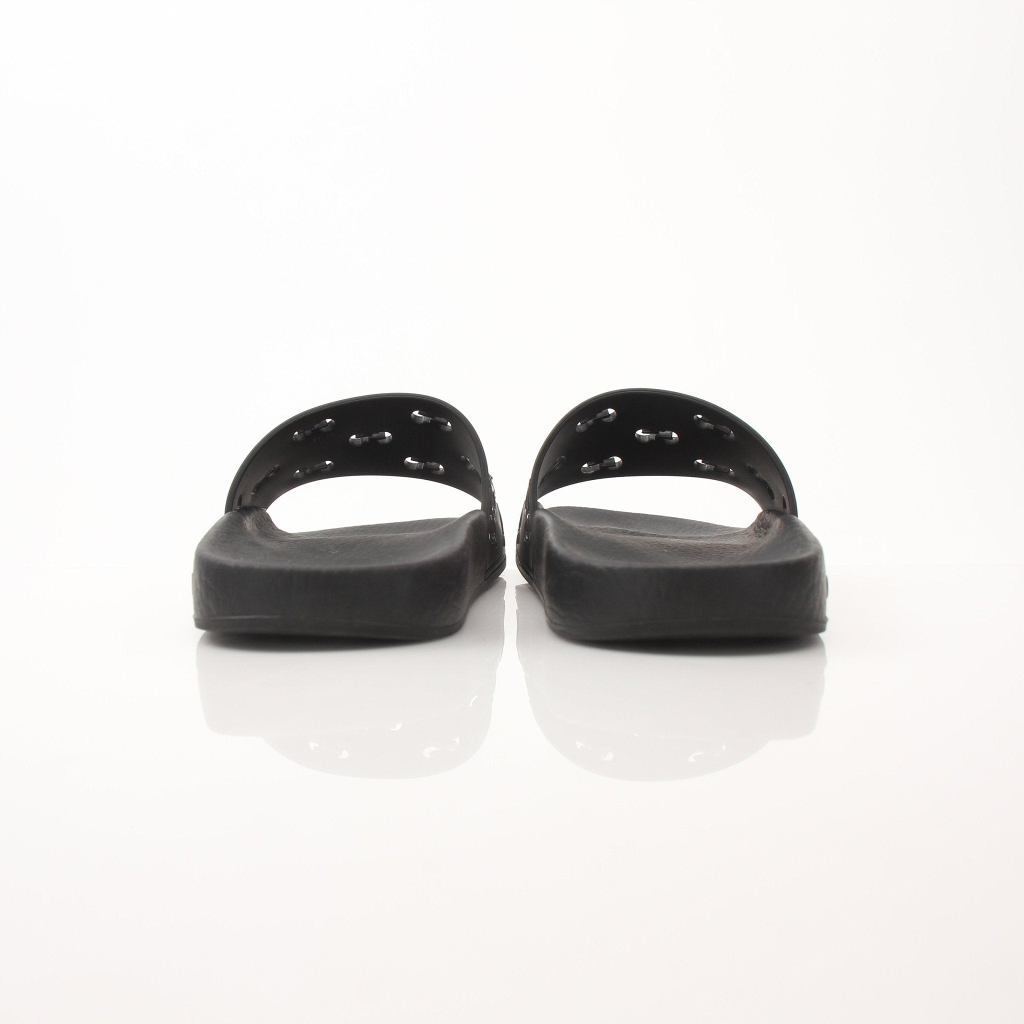 Gucci Pursuit Slides by Gold & Beyond, stylish slip-on shoes with a sleek design, showcased on a neutral background.