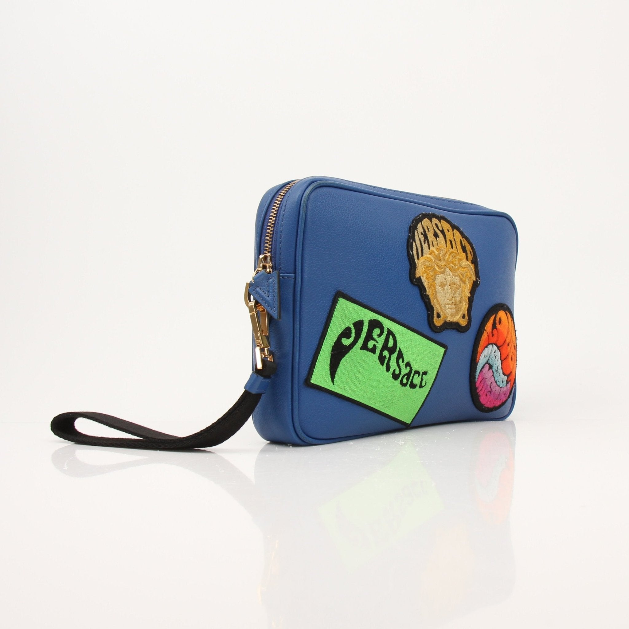 Large blue Versace men's wristlet handbag with gold accents, featuring a sleek design and wrist strap for easy carrying.