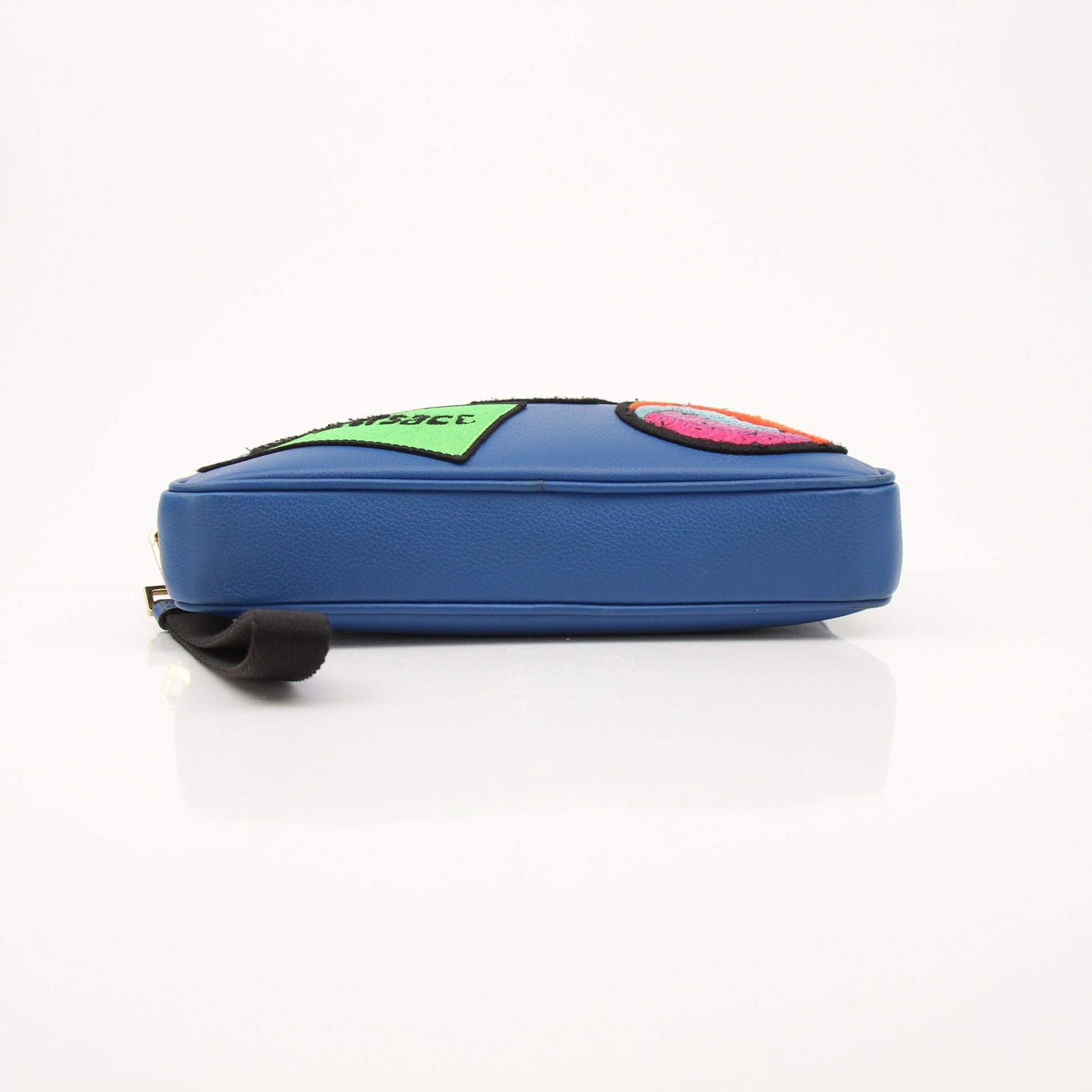 Large blue Versace men's wristlet handbag with gold accents, featuring a sleek design and textured material.