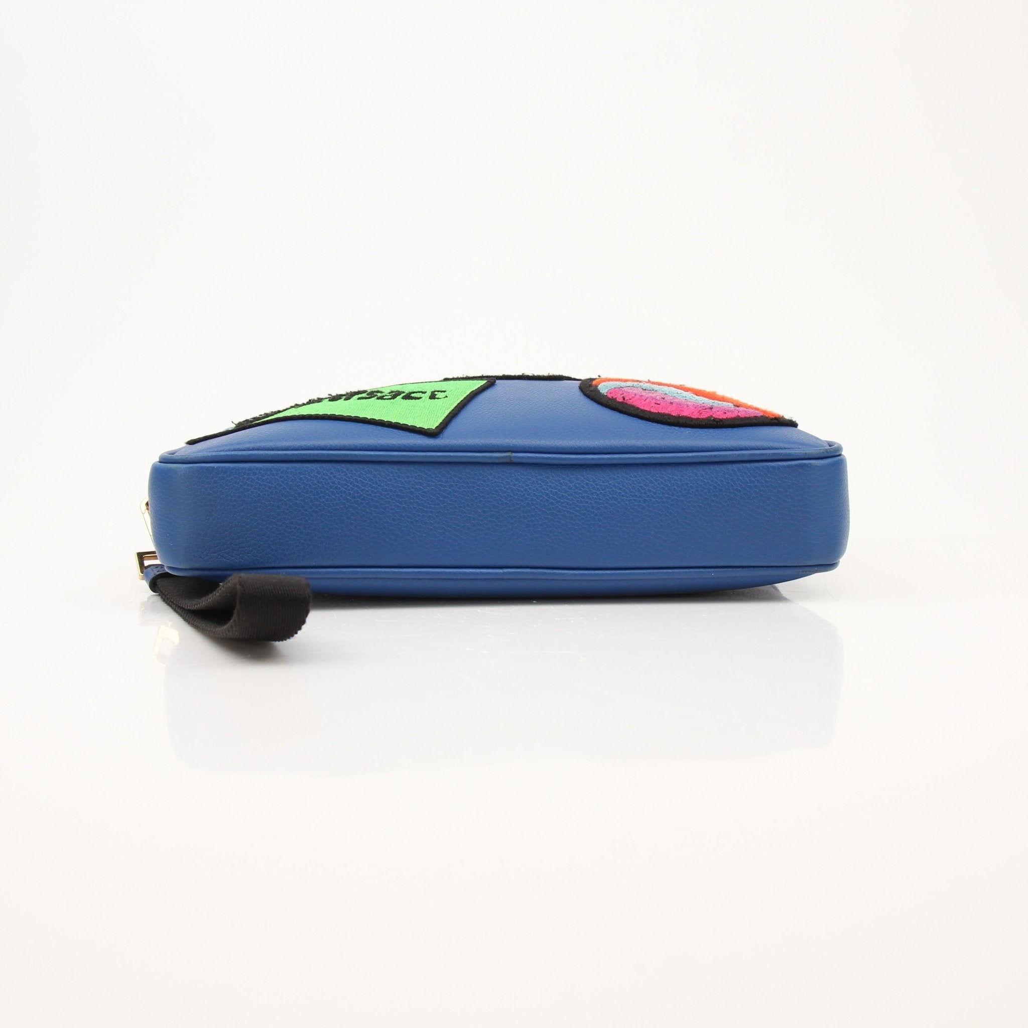 Large blue Versace men's wristlet handbag with gold accents, featuring a sleek design and textured material.