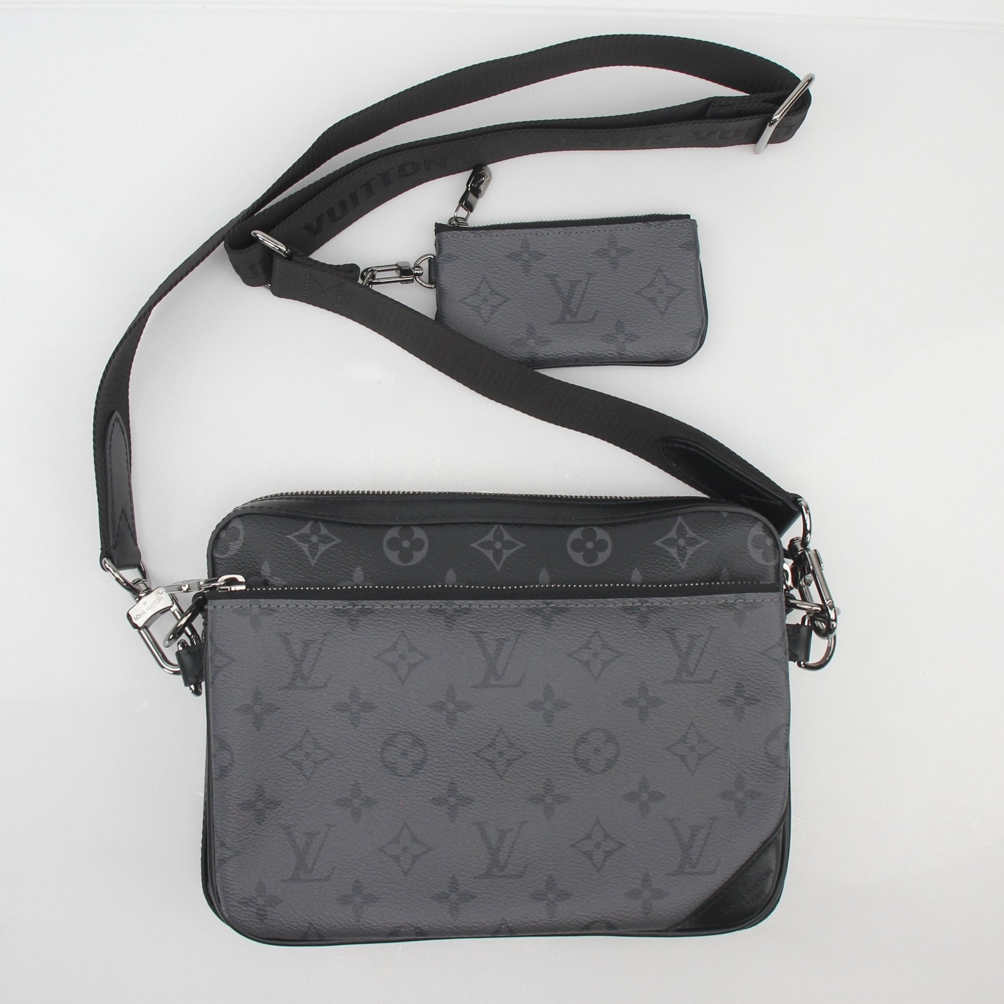 Louis Vuitton Monogram Eclipse Trio Messenger Bag, black and gray canvas handbag with leather accents and adjustable strap.