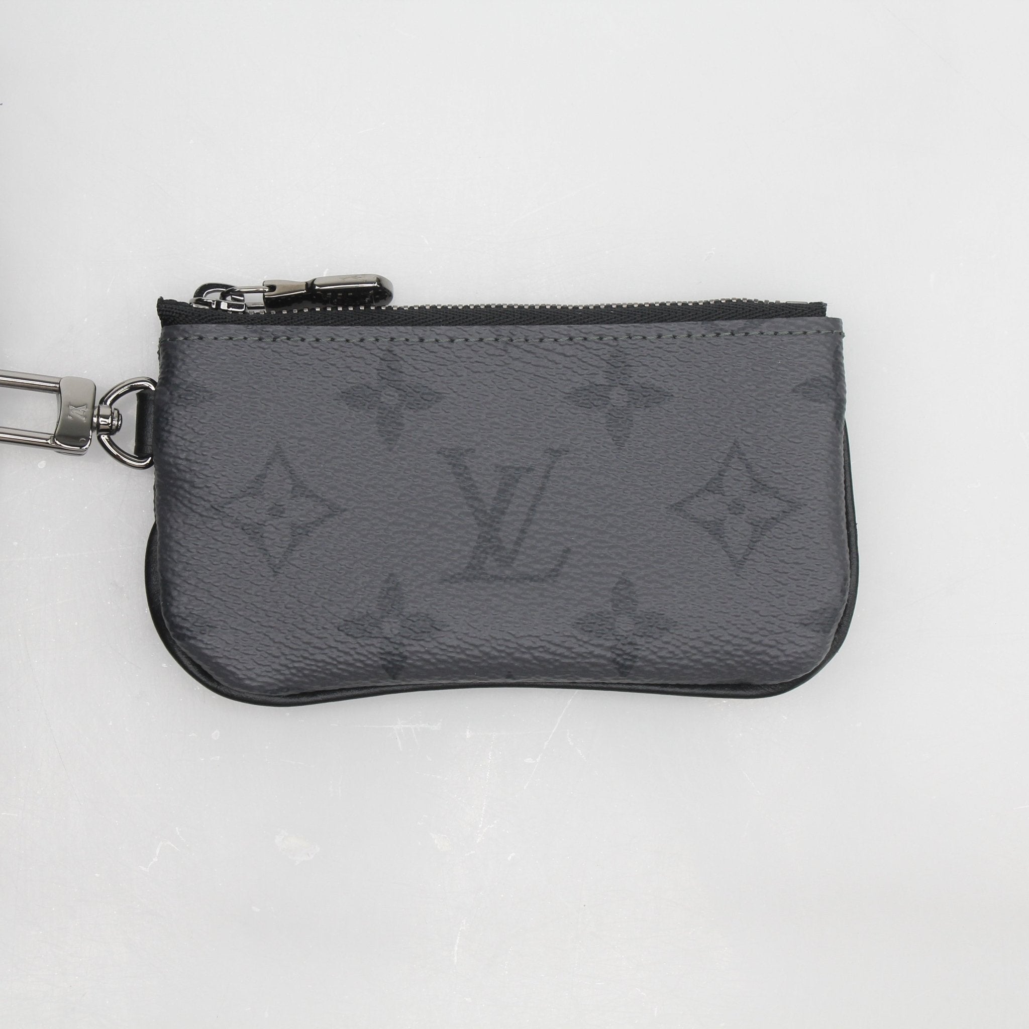Louis Vuitton Monogram Eclipse Trio Messenger Bag in black and gray monogram canvas with leather accents, featuring multiple compartments.
