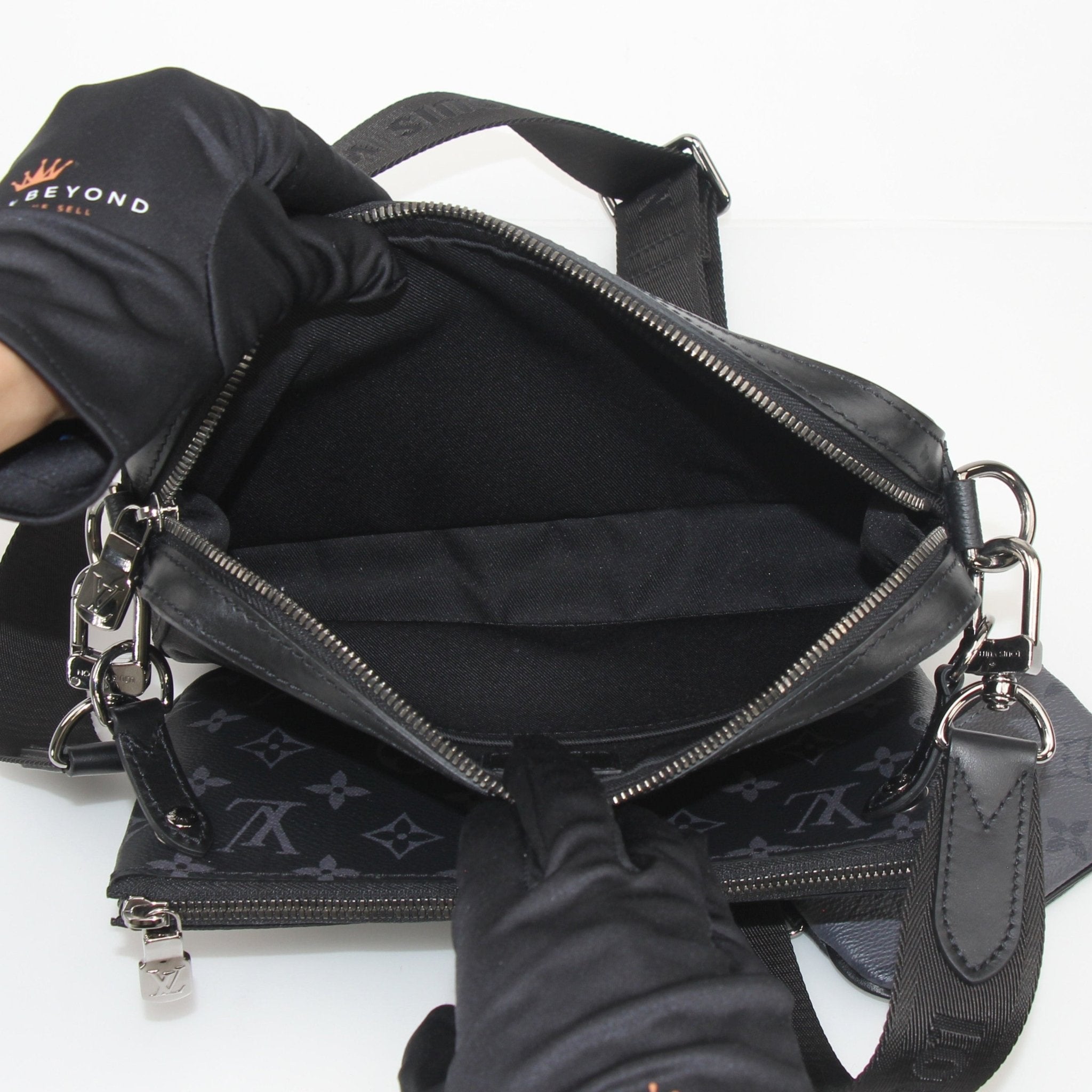 Louis Vuitton Monogram Eclipse Trio Messenger Bag, stylish handbag with monogram pattern and adjustable strap, crafted by Gold & Beyond.