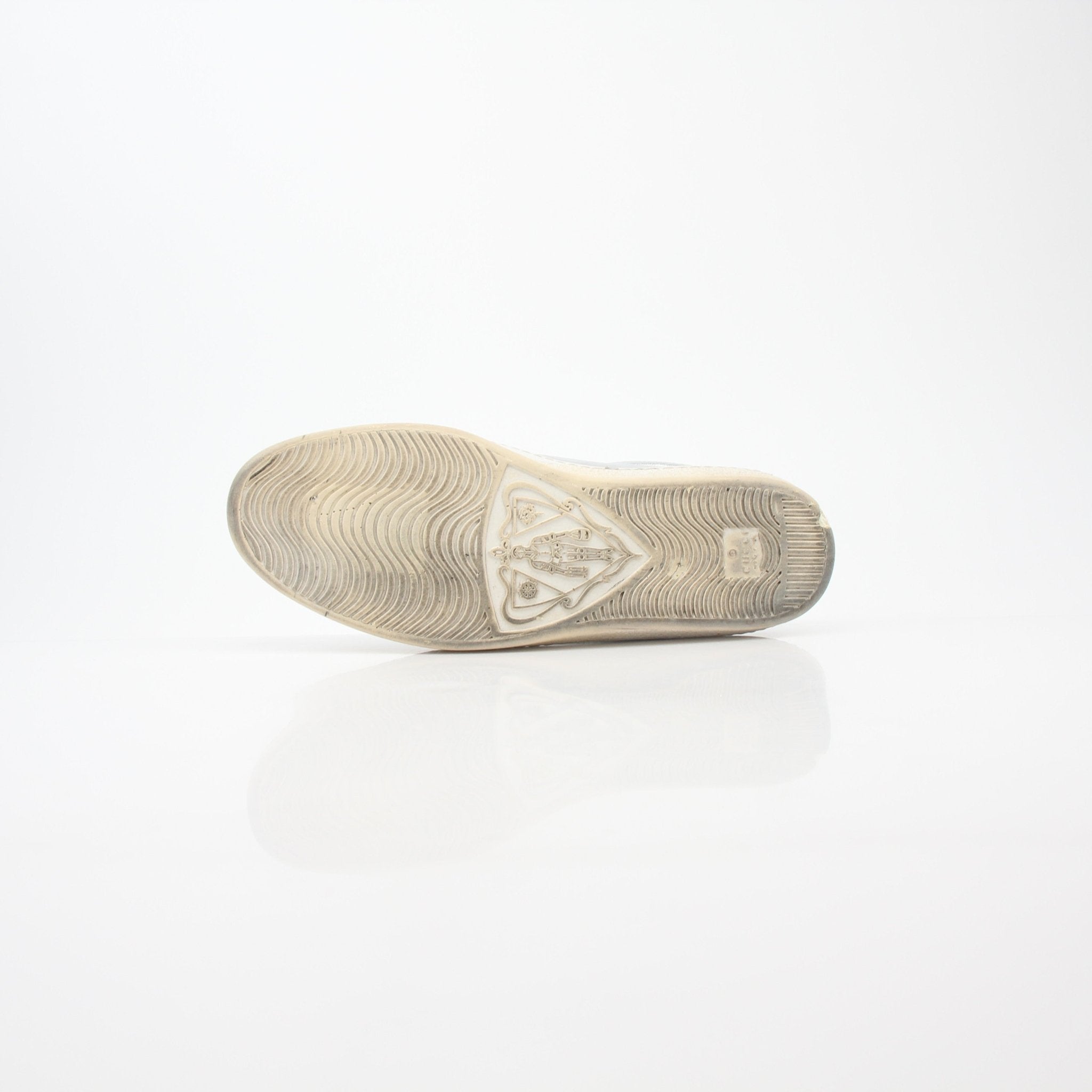 Silver Gucci Ace perforated logo sneakers with metallic finish and white rubber soles, stylish shoes for casual wear.