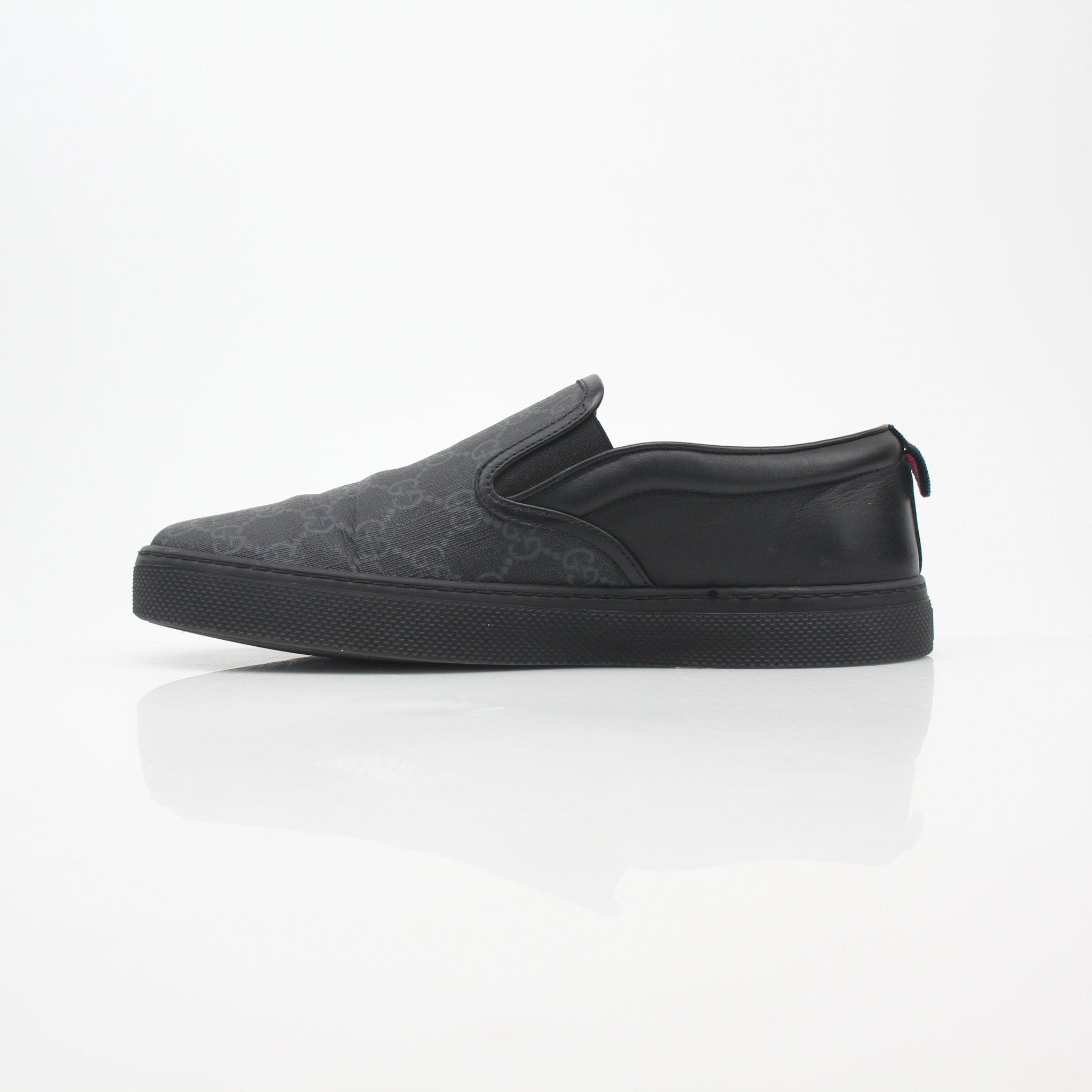 Gucci Black GG Supreme Dublin slip-on sneakers, stylish shoes with iconic logo pattern and comfortable design.