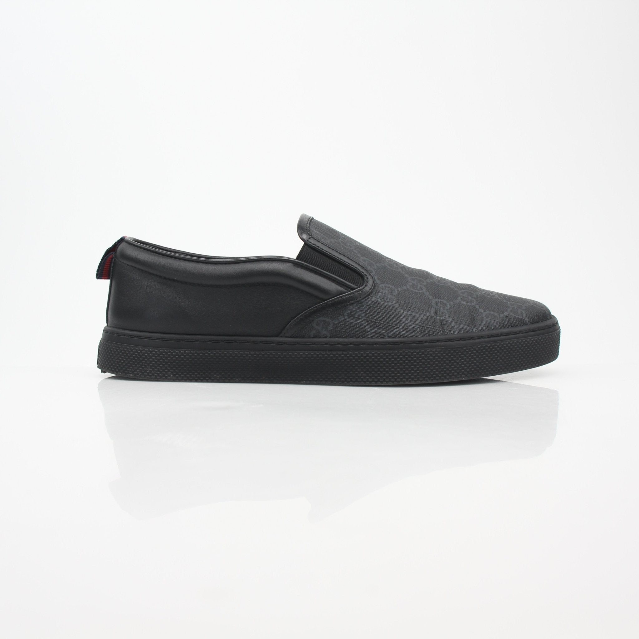Gucci Black GG Supreme Dublin slip-on sneakers with leather details and rubber sole, stylish footwear by Gold & Beyond.