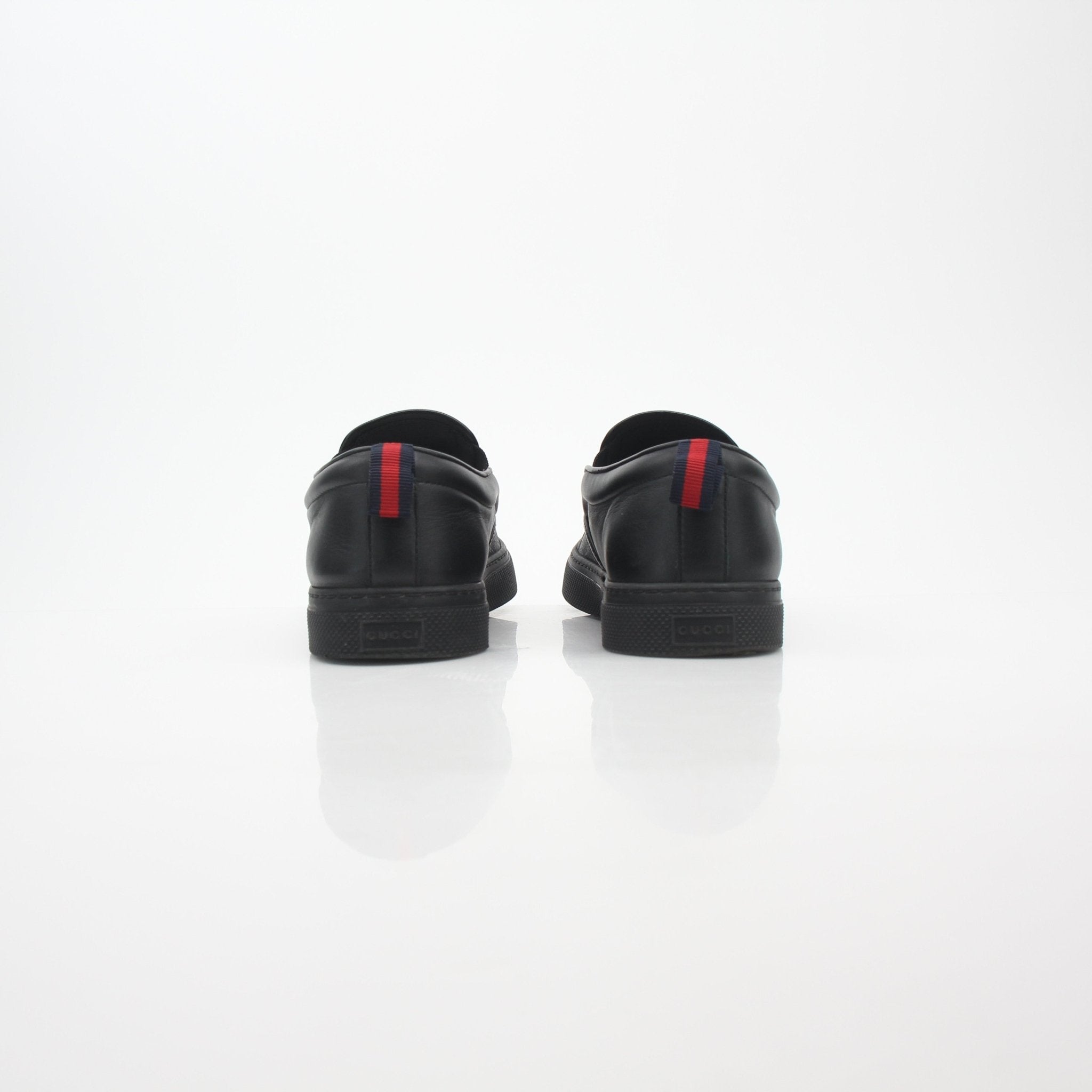 Gucci black GG Supreme Dublin slip-on sneakers with white rubber soles, stylish and comfortable shoes from Gold & Beyond.