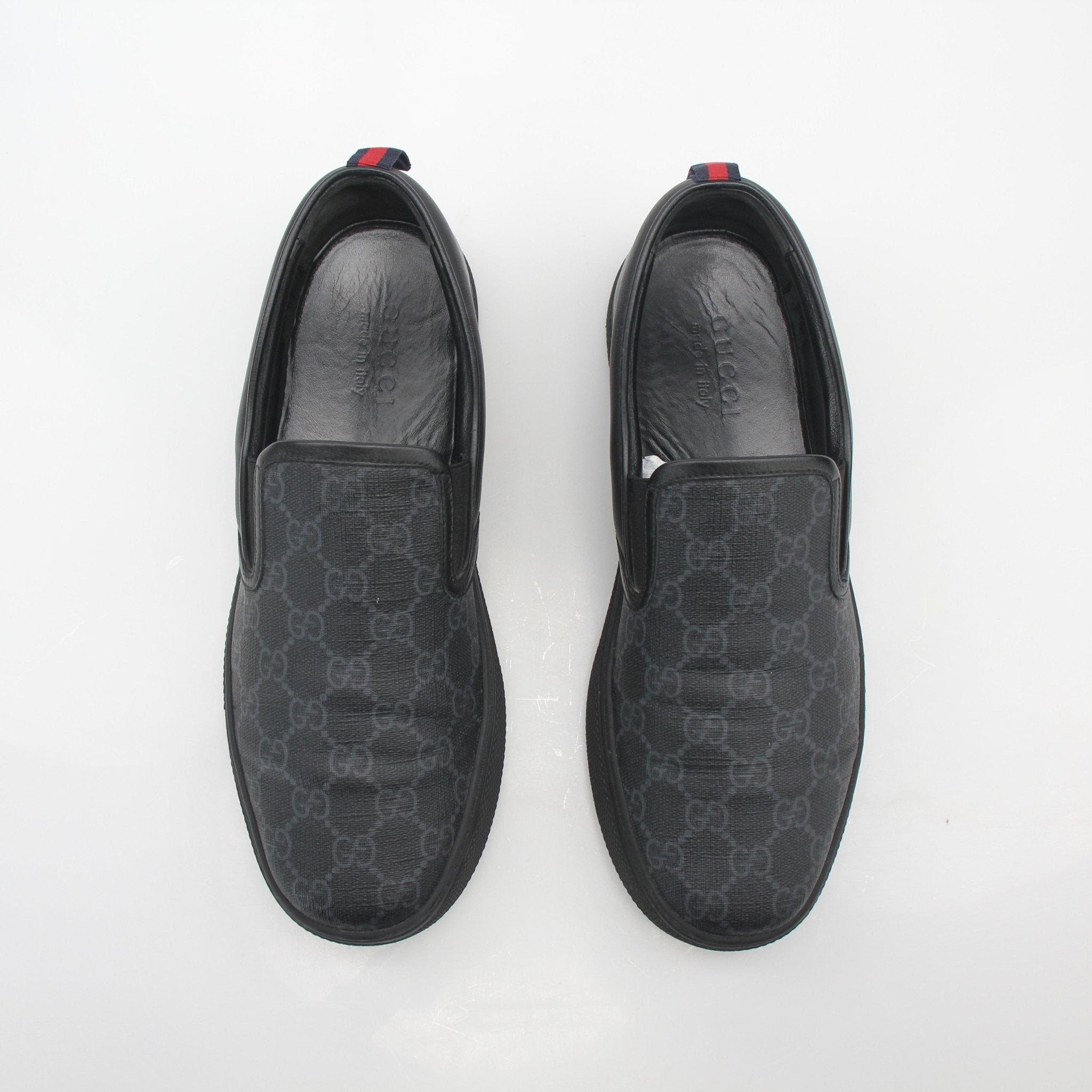 Gucci Black GG Supreme Dublin slip-on sneakers with white sole and gold accents, stylish shoes by Gold & Beyond.
