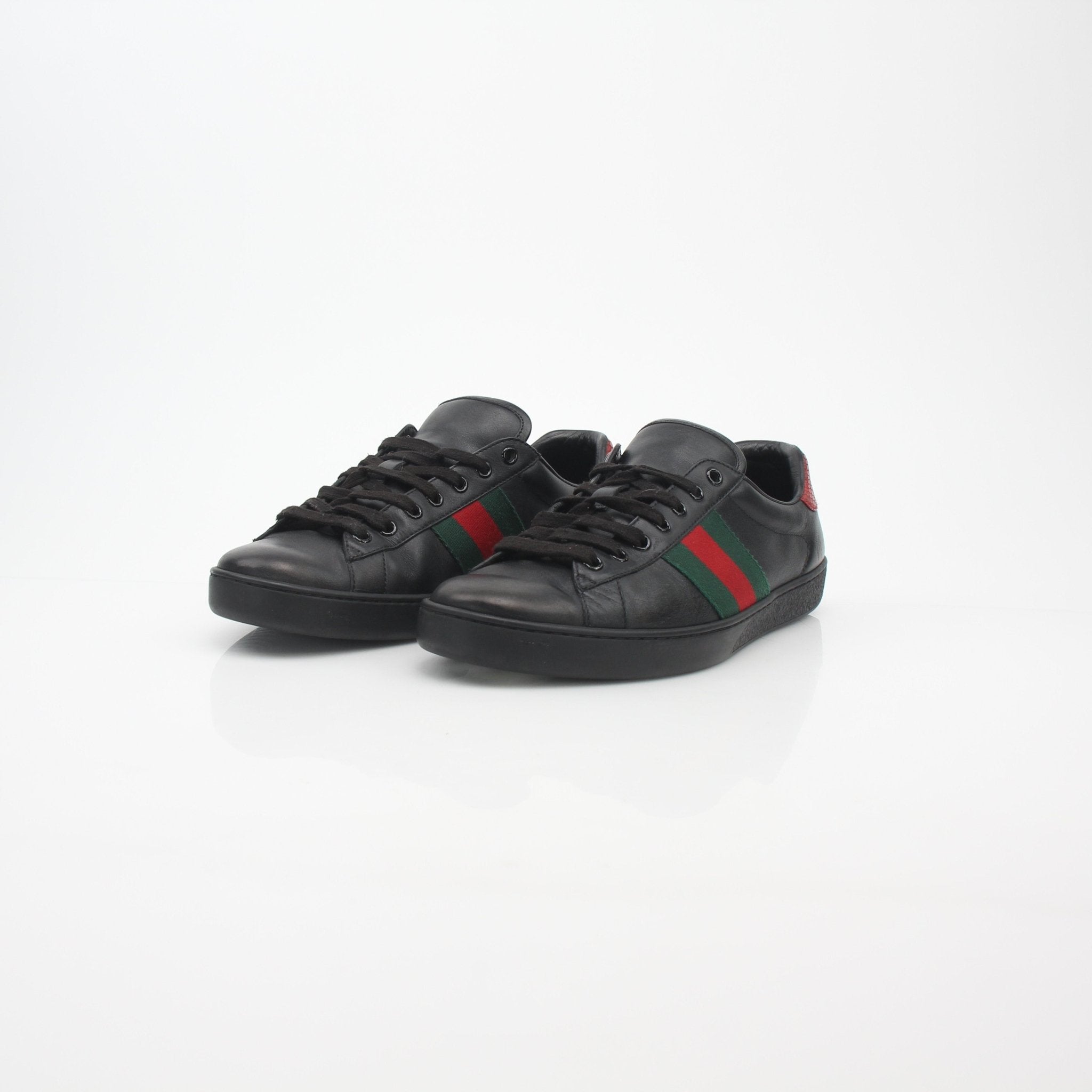 Gold & Beyond Gucci Black Ace Web low-top sneakers with classic design, featuring black leather and signature web detailing.