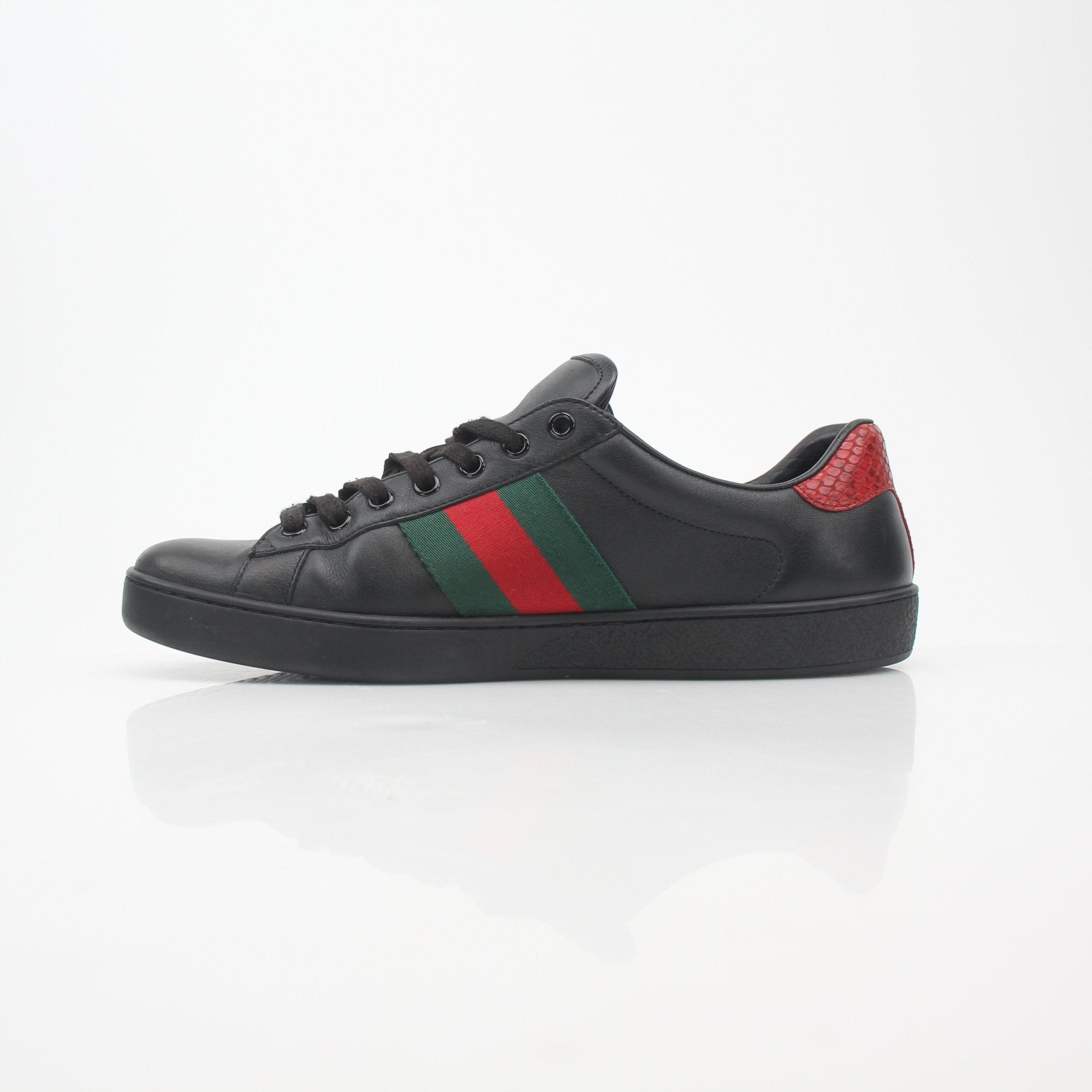 Gucci Black Ace Web low-top sneakers with signature design, displayed on a plain background, showcasing stylish footwear from Gold & Beyond.