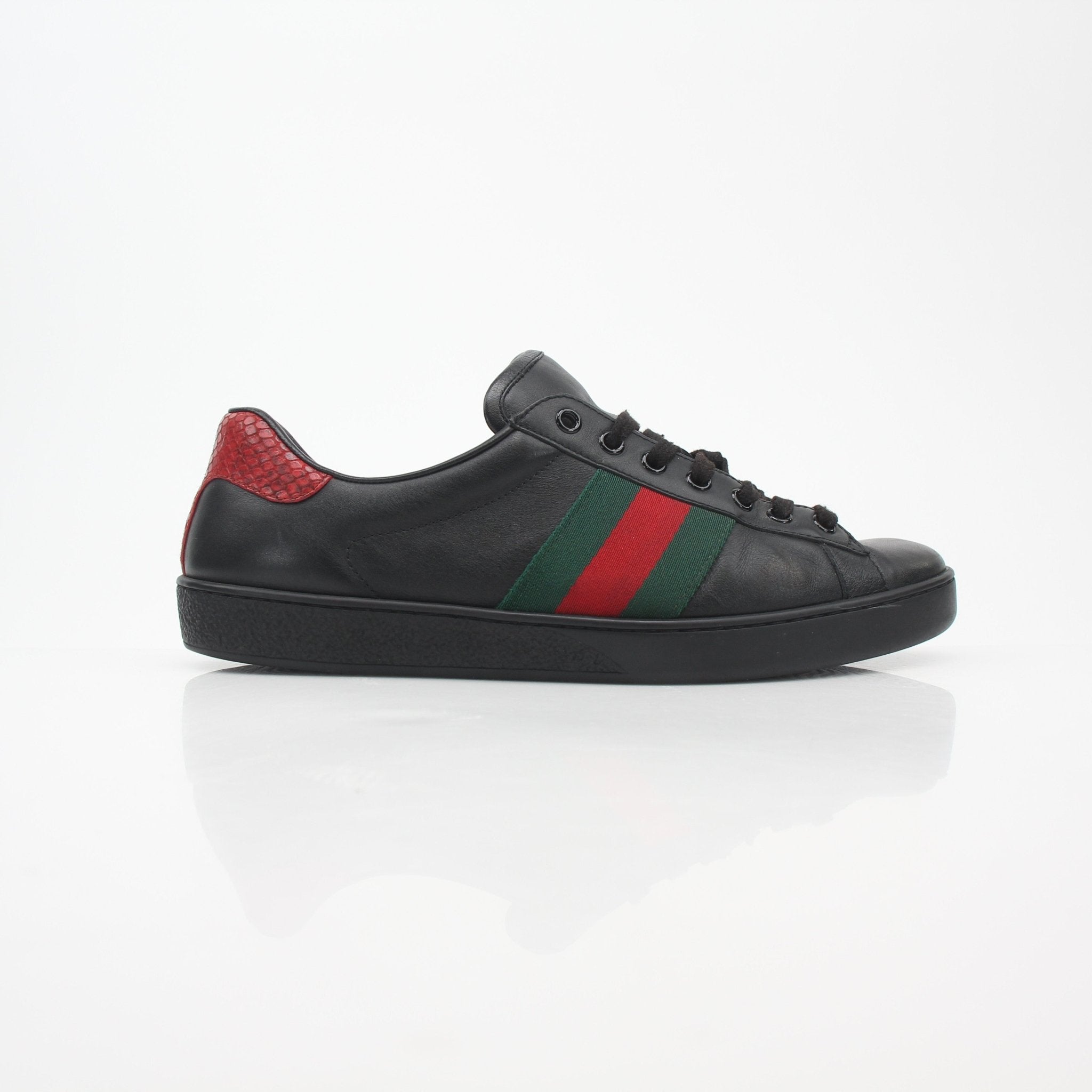 Black Gucci Ace Web low-top sneakers with signature design, displayed on a neutral background, showcasing the stylish shoe details.