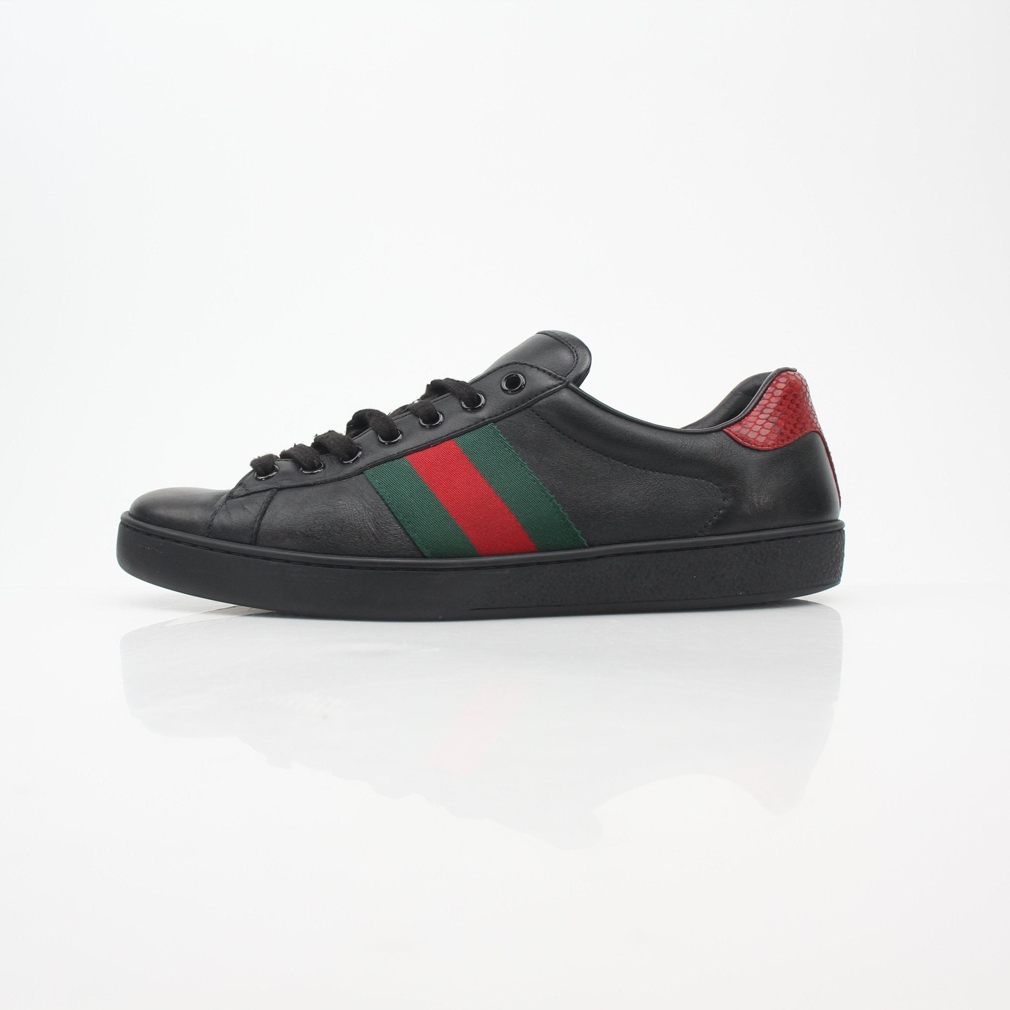 Gold & Beyond Gucci Black Ace Web low-top sneakers with classic design, featuring black leather and web stripe detailing.