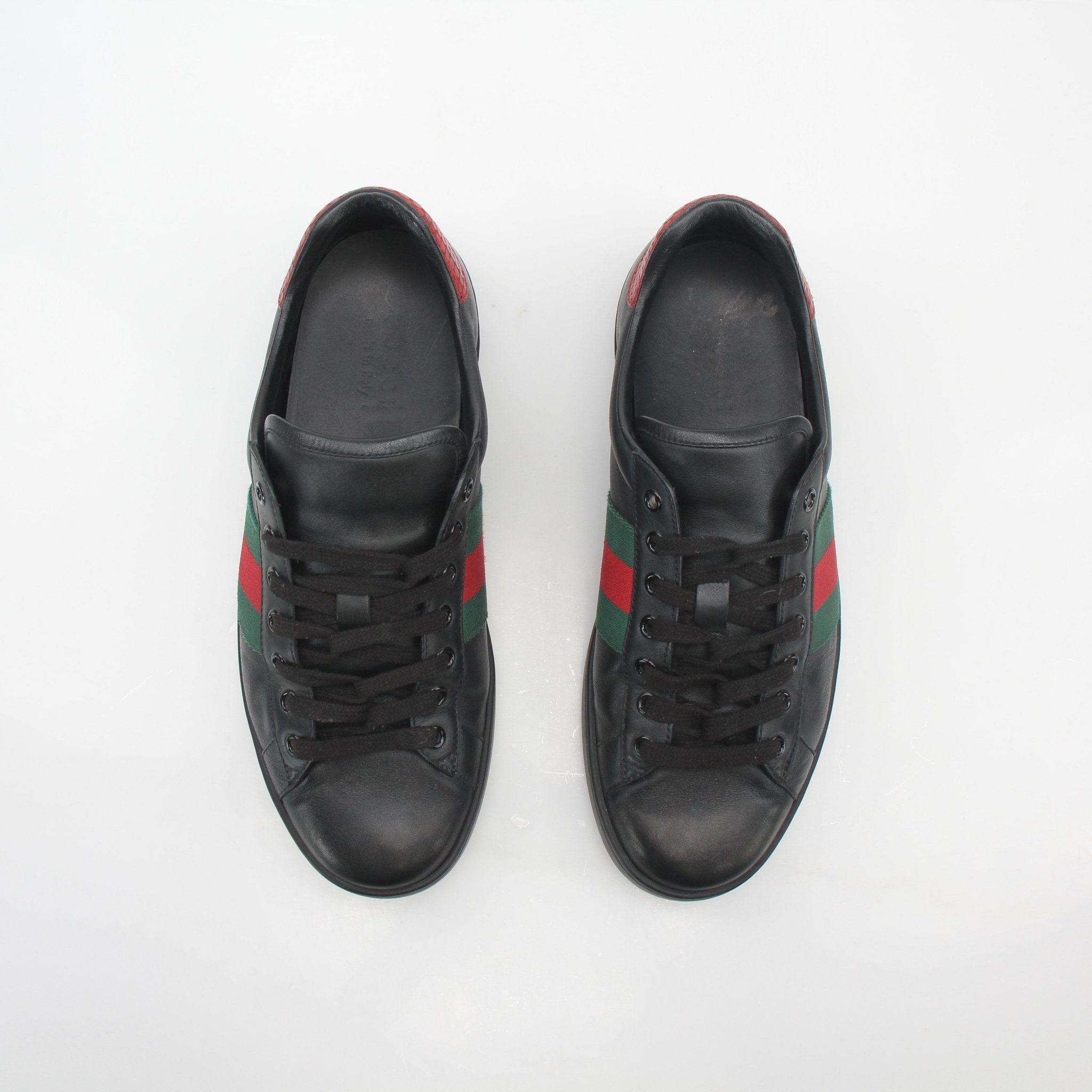 Gucci Black Ace Web low-top sneakers with white rubber soles and signature green and red web detail, crafted by Gold & Beyond.