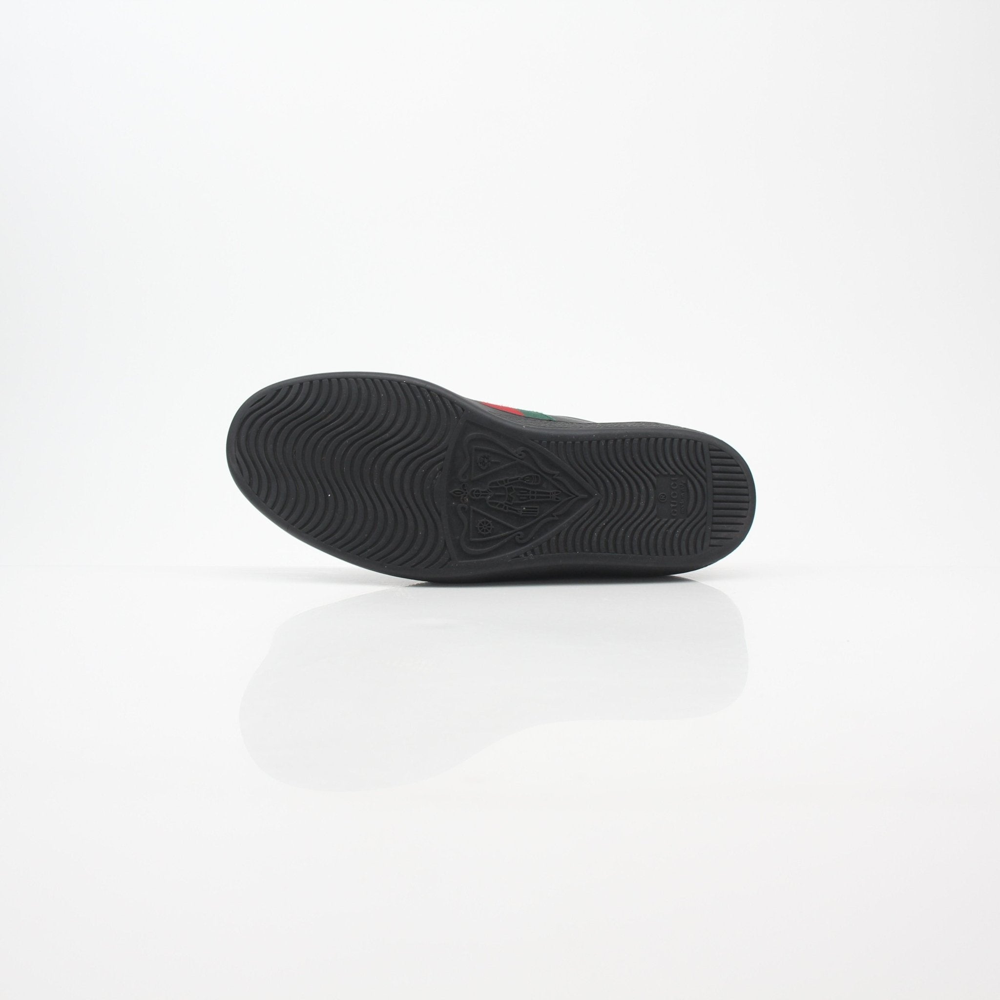 Gucci Black Ace Web low-top sneakers with signature web detail and white rubber soles, displayed on a plain background.
