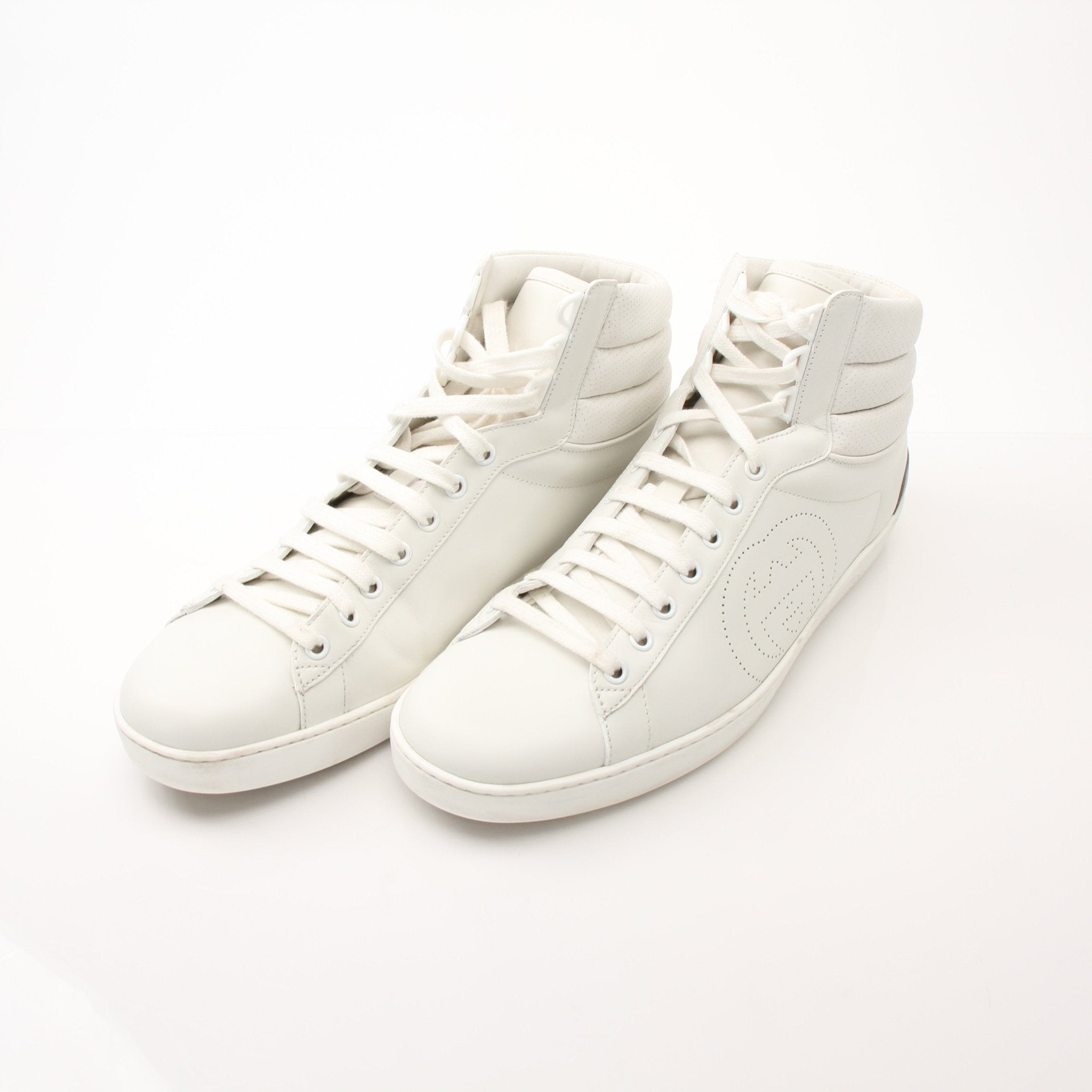Gold & Beyond Gucci Ace high top sneakers showcasing white leather shoes with signature design and stylish laces.