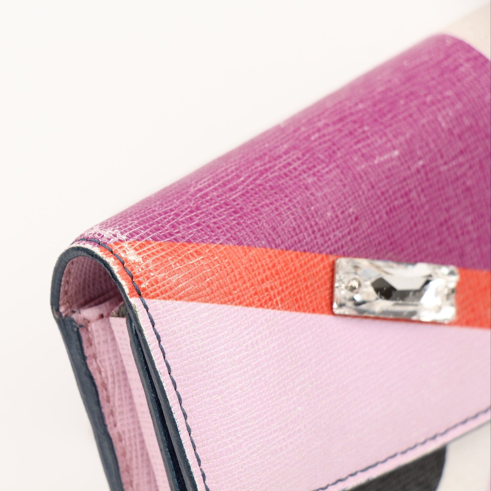 Gold & Beyond Fendi Monster Continental Wallet with signature design and multiple card slots, showcasing luxury leather details.