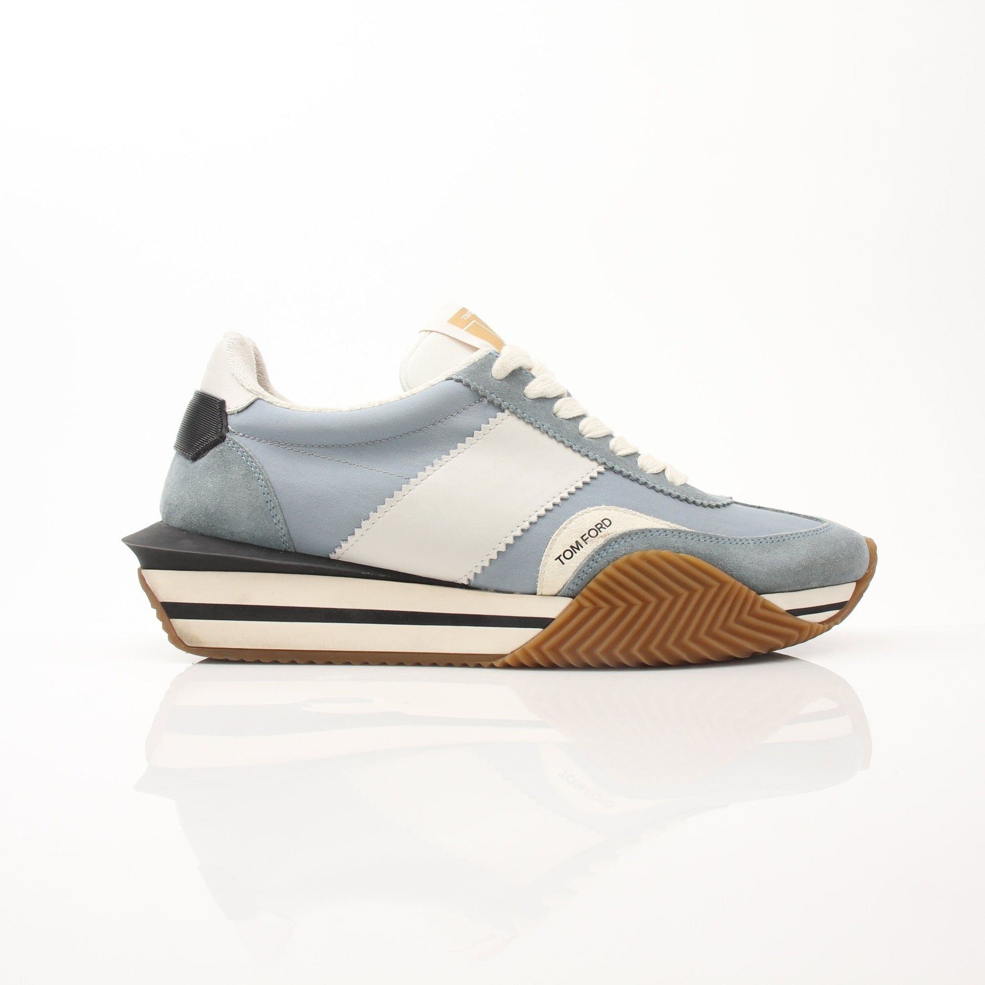 Tom Ford sneakers from Gold & Beyond featuring sleek design, white leather uppers, and stylish laces.