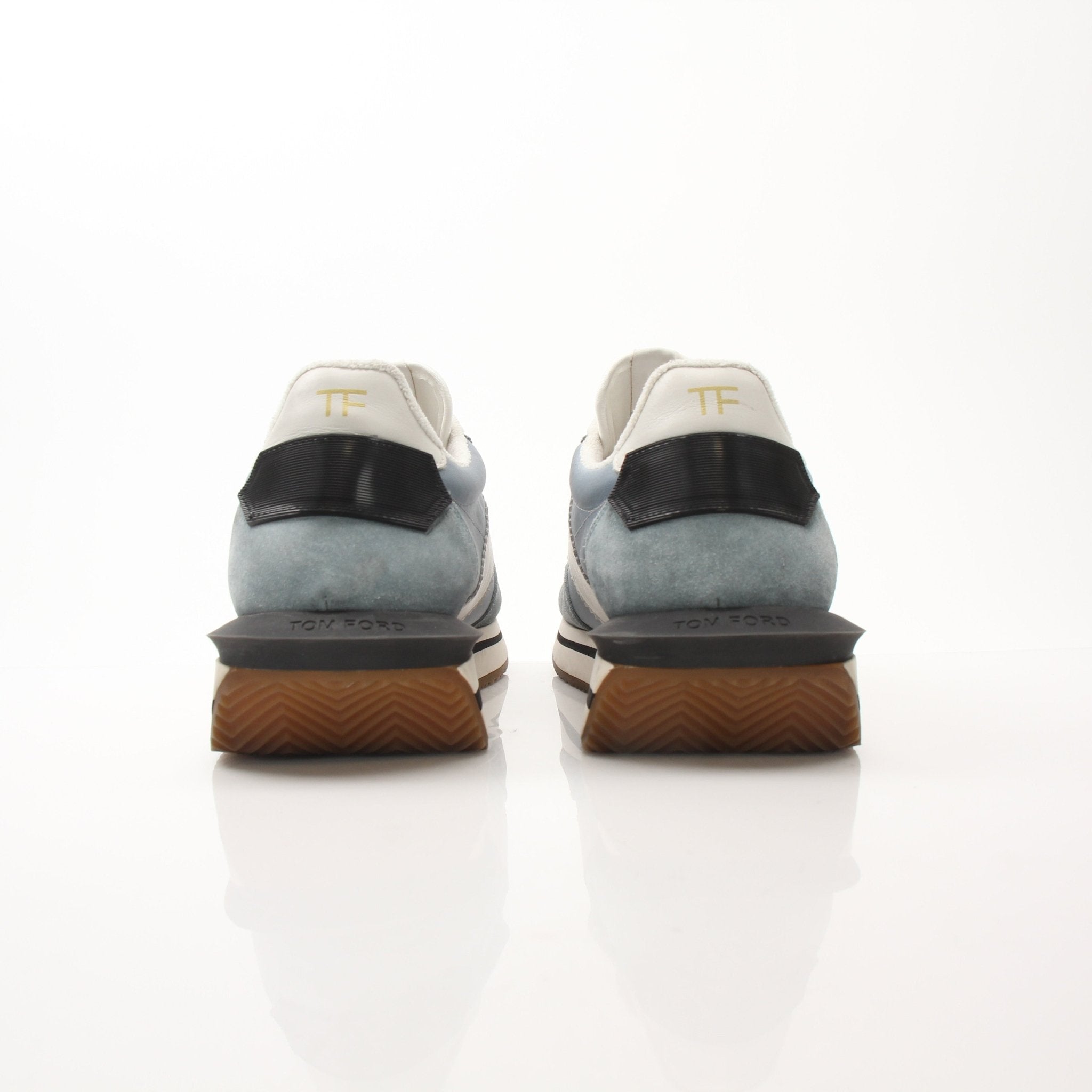 Tom Ford trainers shoes in black with white soles, featuring sleek design and stylish branding, on a white background.