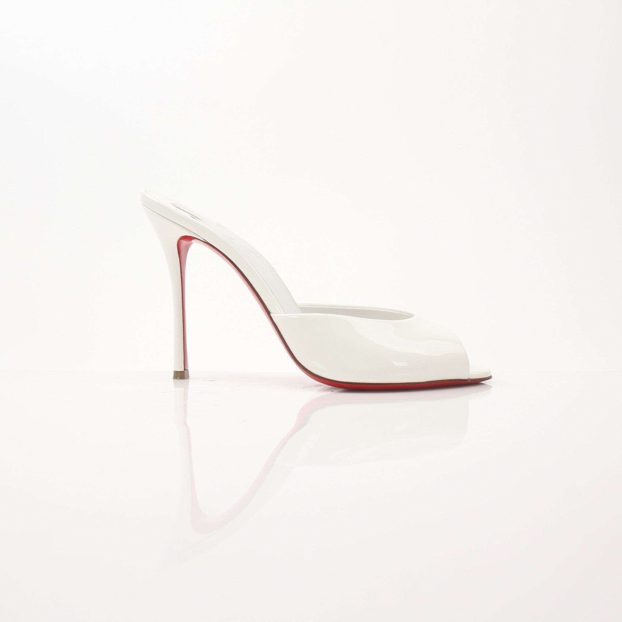Christian Louboutin White Me Dolly Mules, stylish shoes with pointed toes and signature red soles, displayed on a neutral background.