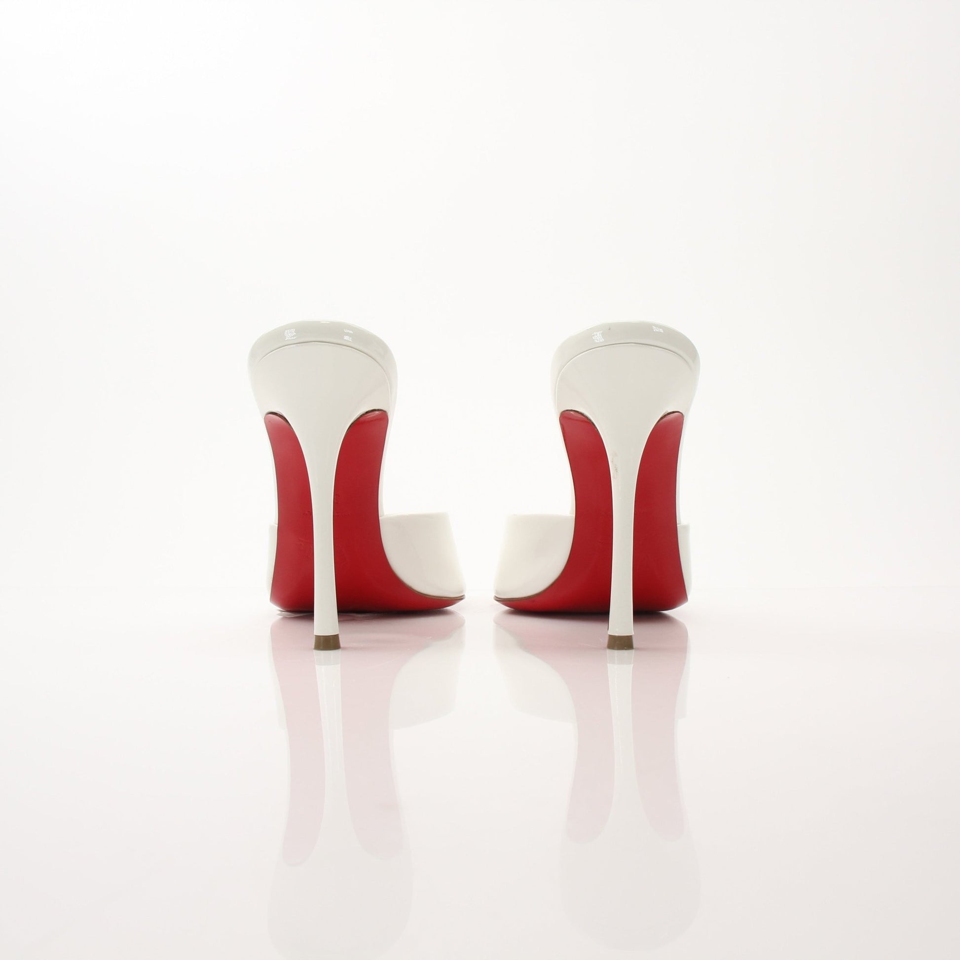 Christian Louboutin White Me Dolly Mules shoes with signature red soles and elegant design, displayed on a neutral background.