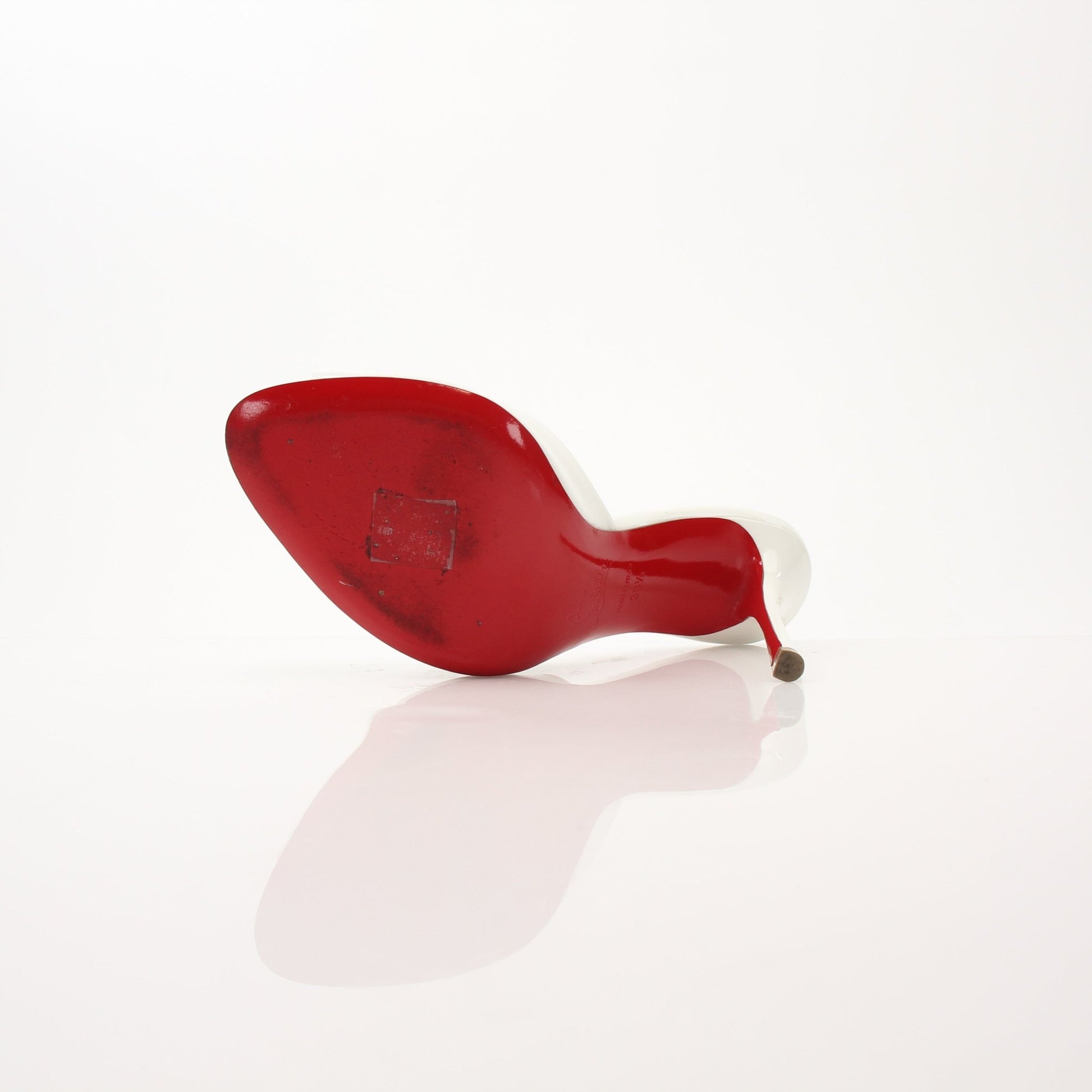 Christian Louboutin White Me Dolly Mules shoes with sleek design and signature red sole detail, displayed on a neutral background.