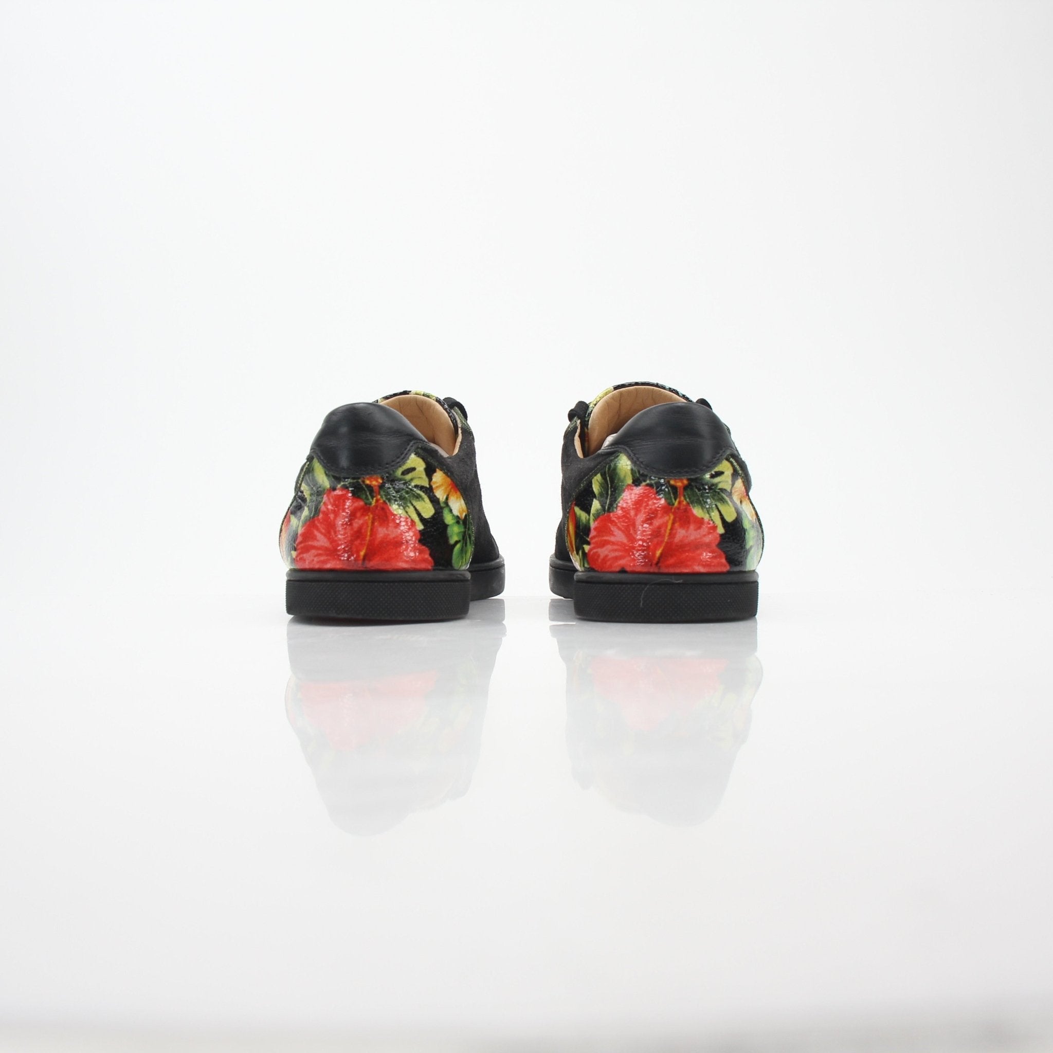Christian Louboutin Black Louis Junior Floral low-top sneakers with designer details and floral accents, showcasing stylish footwear.