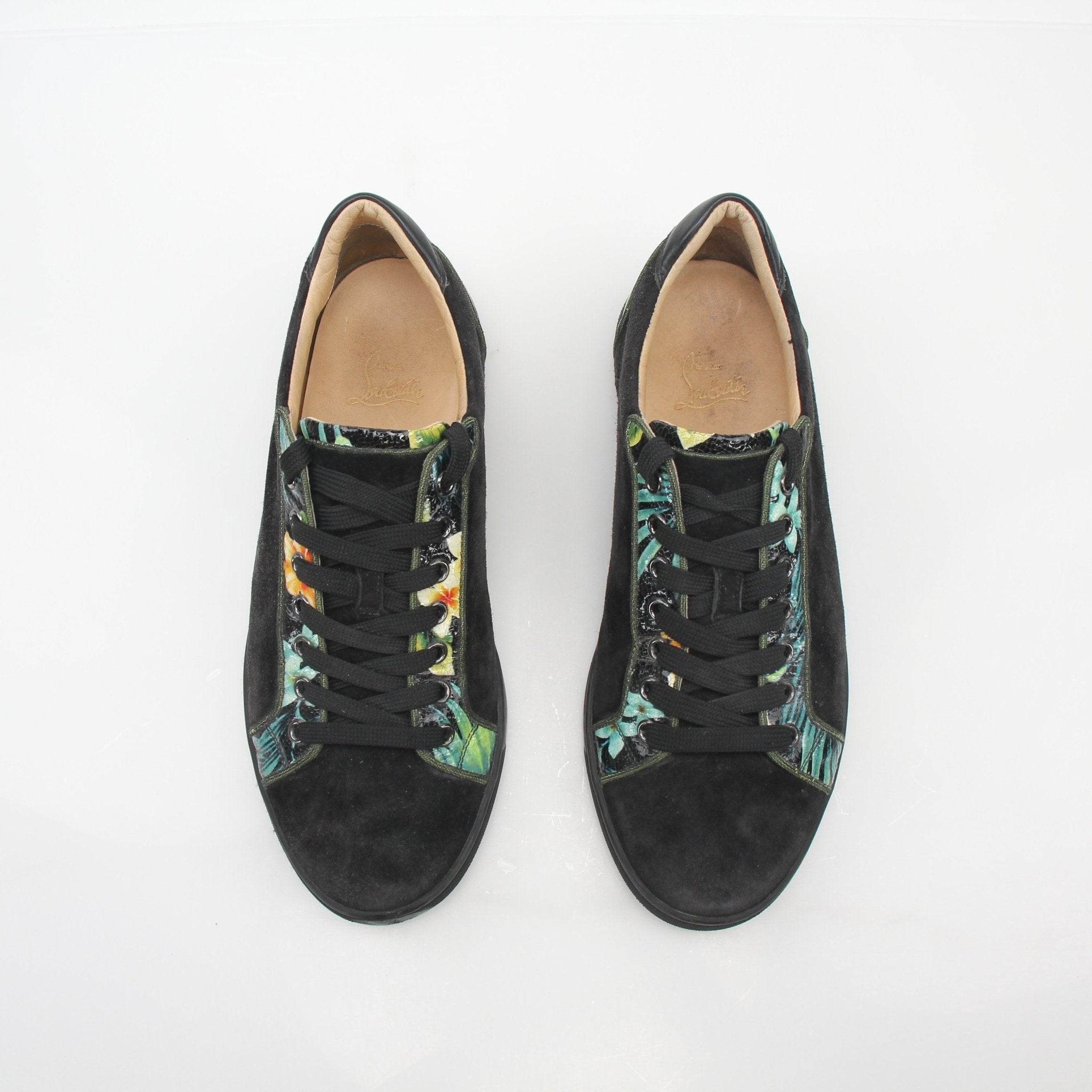 Christian Louboutin Black Louis Junior Floral low-top sneakers with colorful floral details and signature red soles.