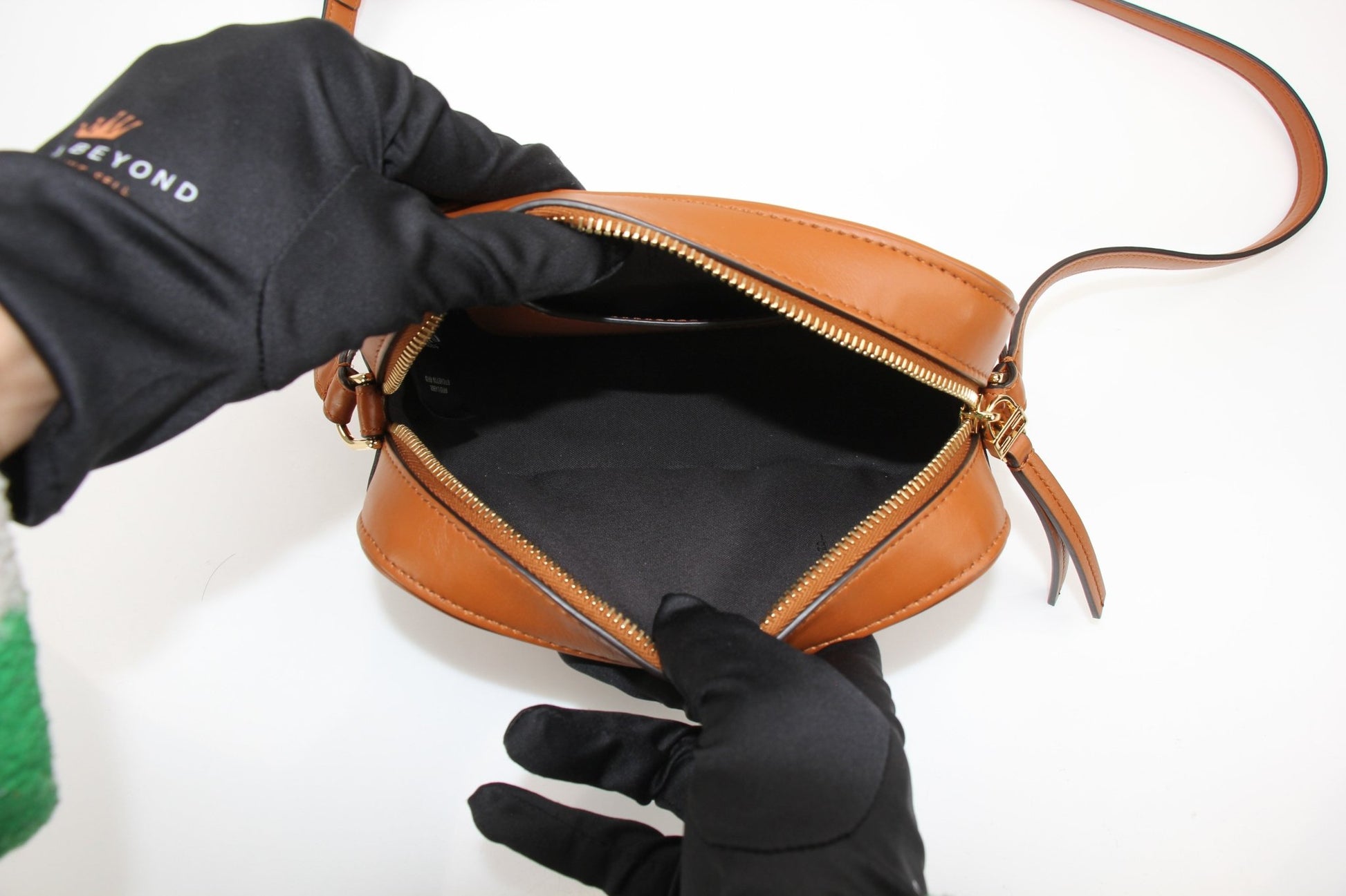 Brown Fendi camera bag wallet with gold accents, featuring a compact design and multiple card slots.