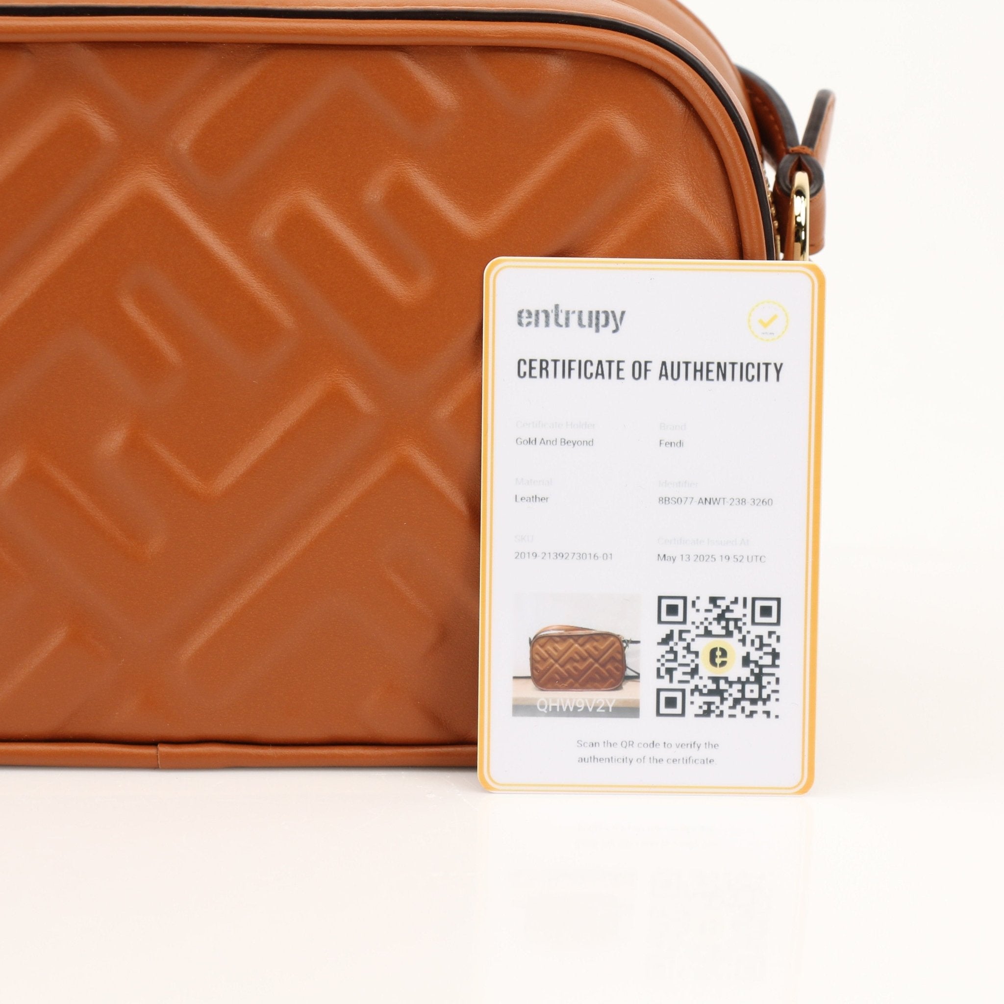 Fendi brown camera bag wallet with gold accents, featuring a compact design and textured leather finish.