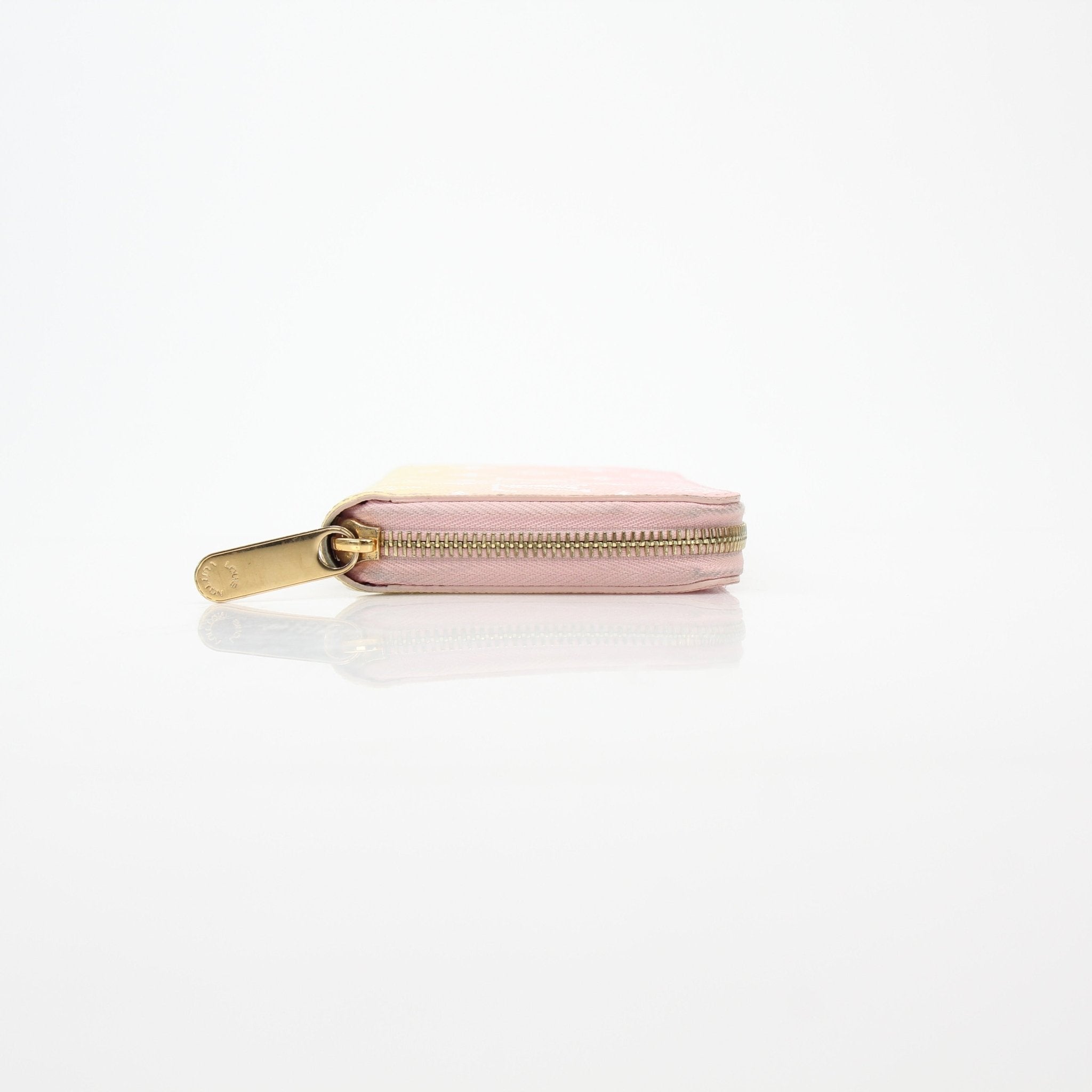 Louis Vuitton By the Pool pink and yellow Zippy Wallet by Gold & Beyond, featuring colorful design and secure zip closure.