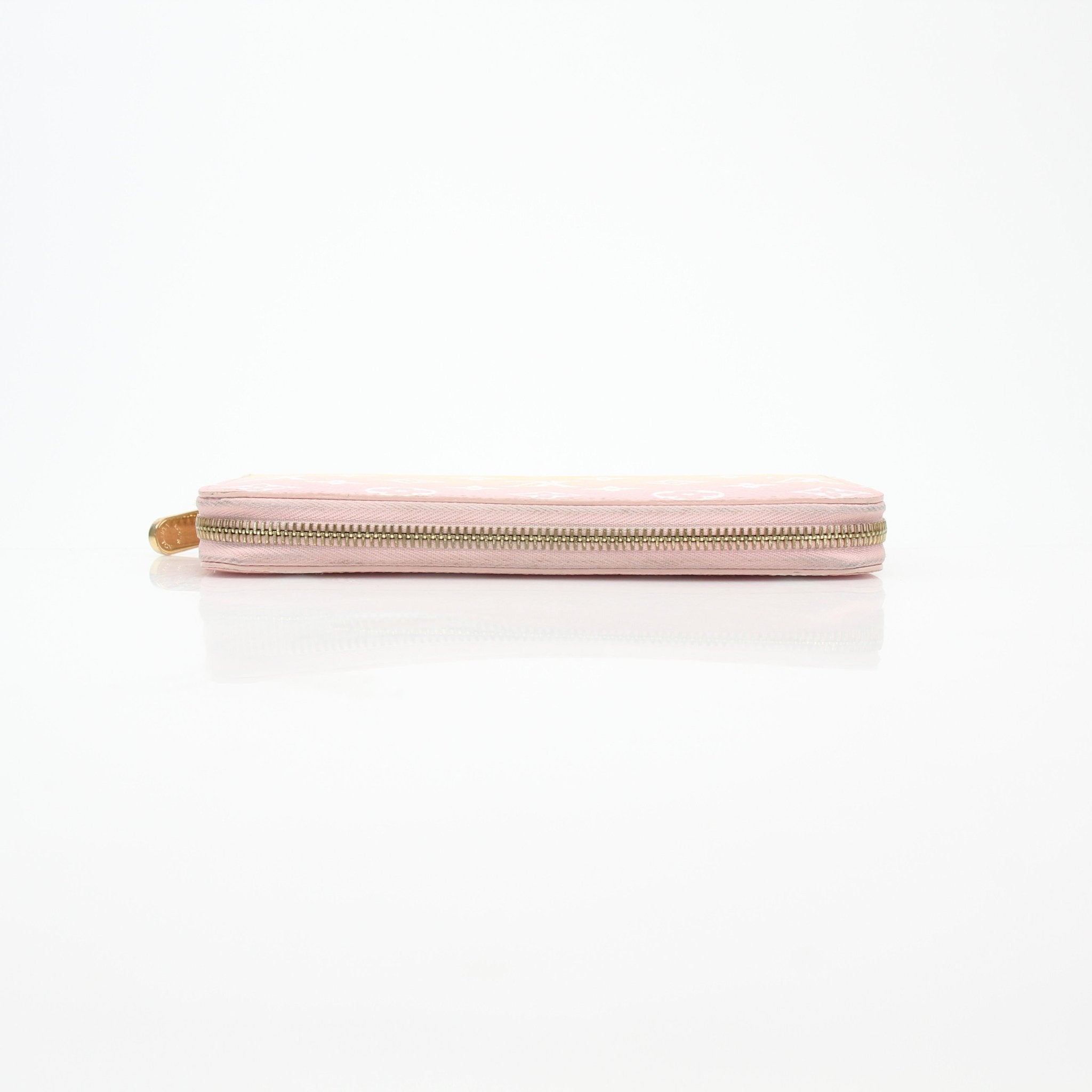 Louis Vuitton By the Pool pink and yellow zippered wallet with gold accents, showcasing vibrant design and compact size.
