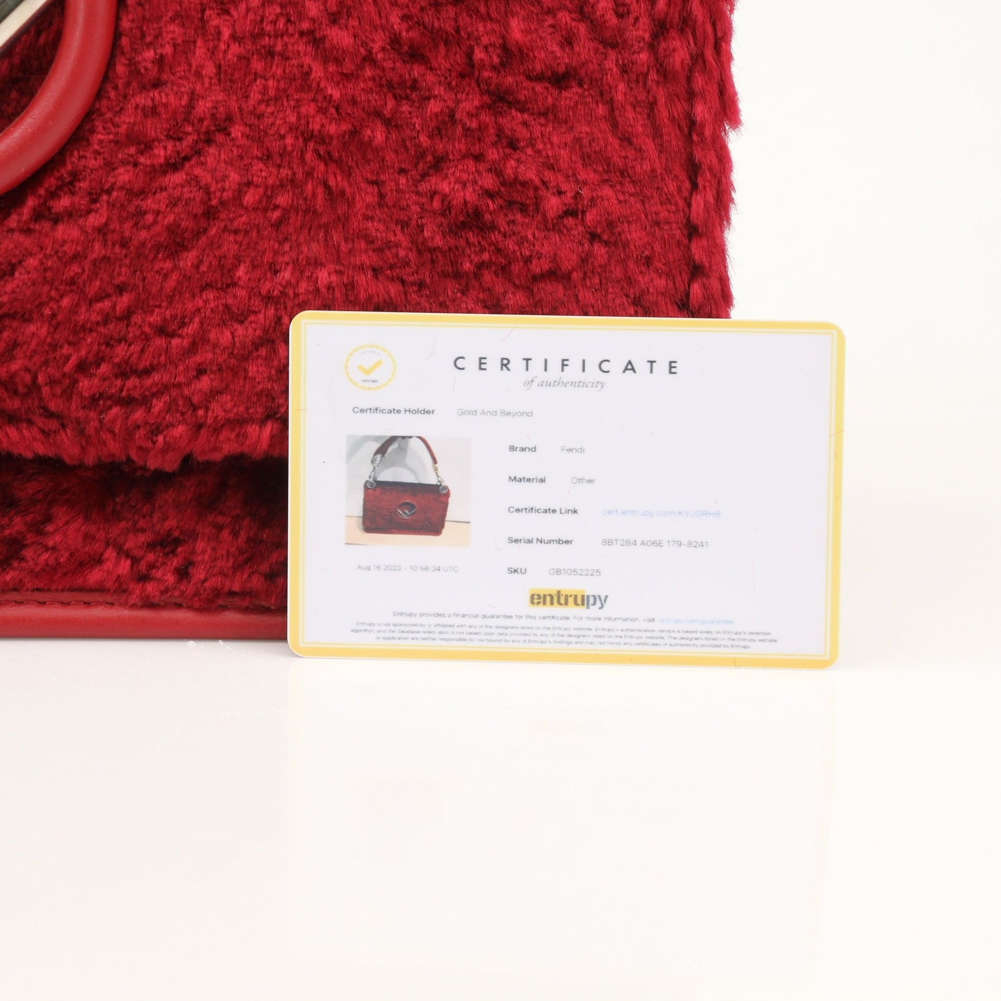 Fendi Kan I F velvet shoulder handbag with gold hardware, featuring a sleek design and luxurious fabric for stylish carrying.