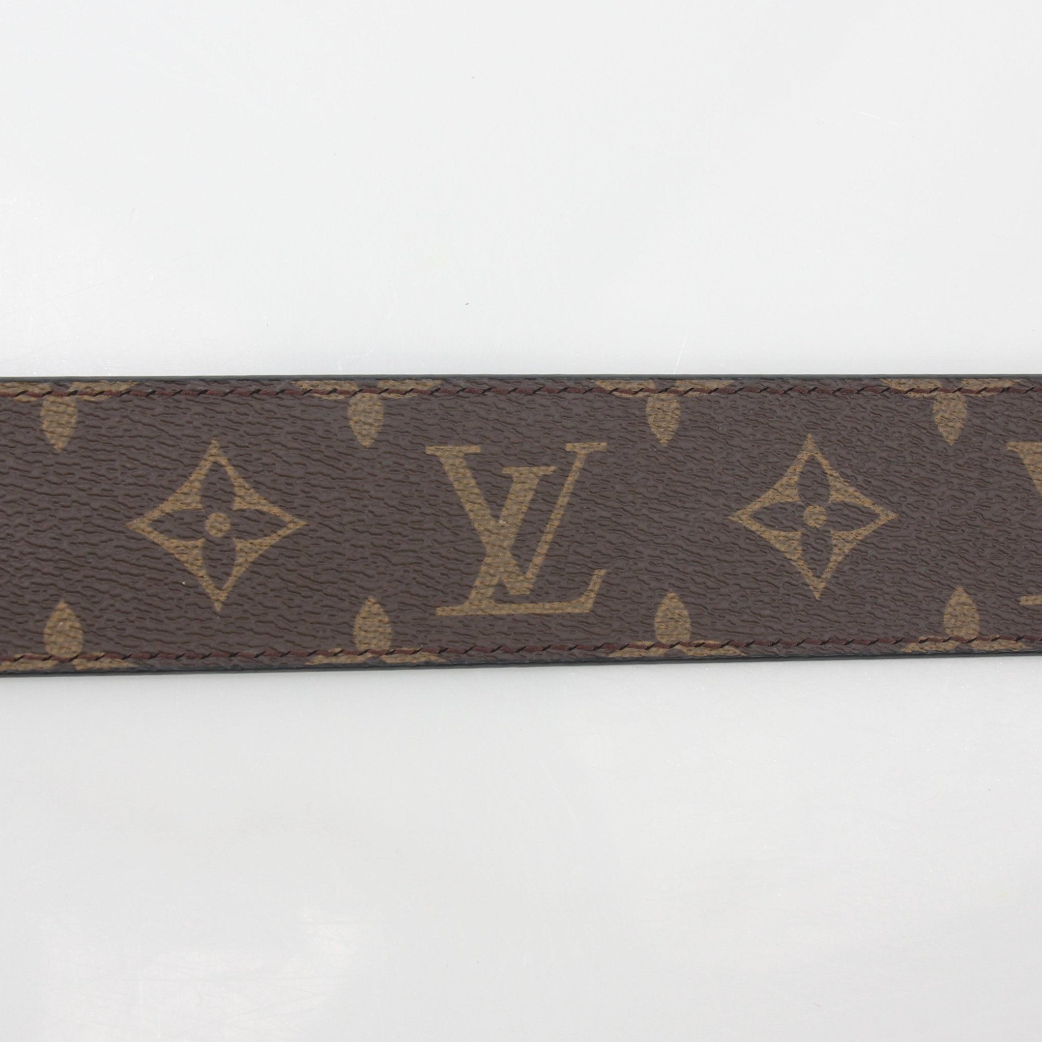 Louis Vuitton Monogram LV Shape 40mm belt with gold buckle, brown leather strap, and signature monogram pattern.