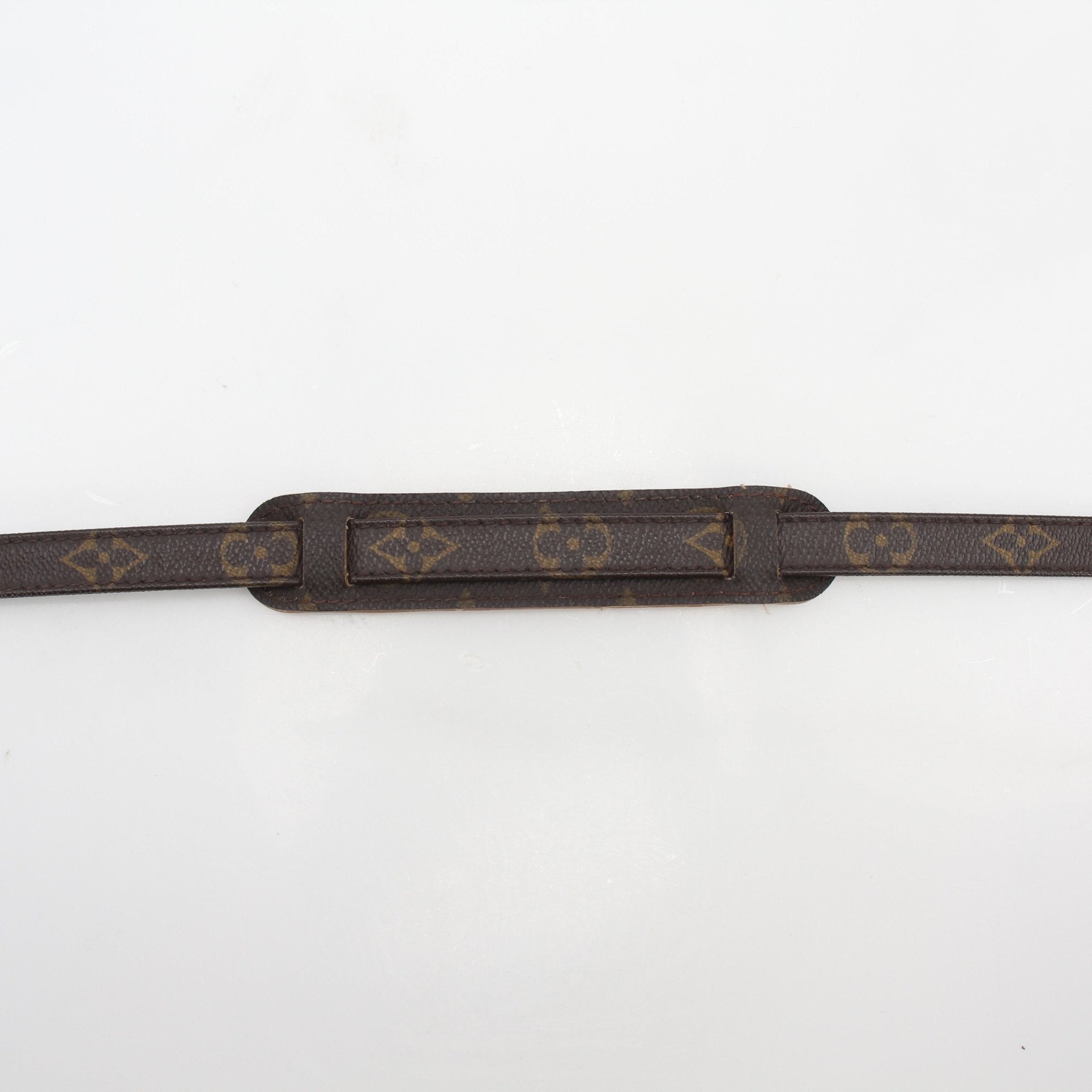 Louis Vuitton Monogram adjustable shoulder strap for accessories, featuring signature monogram pattern and gold-tone hardware.