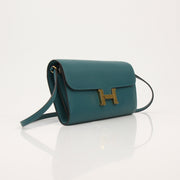Hermès green Constance wallet on chain handbag with gold hardware, featuring sleek design and luxurious leather details.