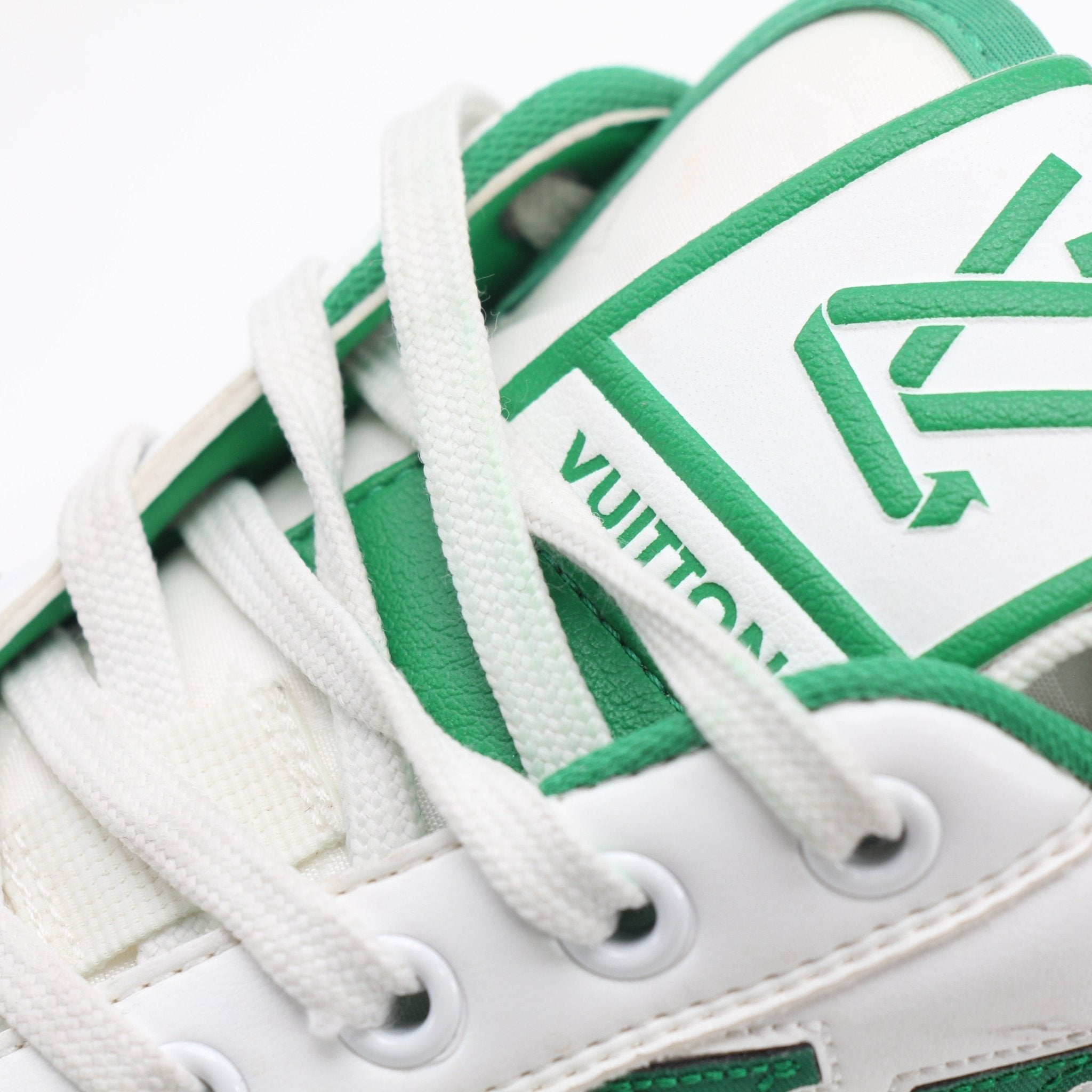 Louis Vuitton white and green Charlie low-top sneakers by Gold & Beyond, featuring a stylish design and casual footwear style.