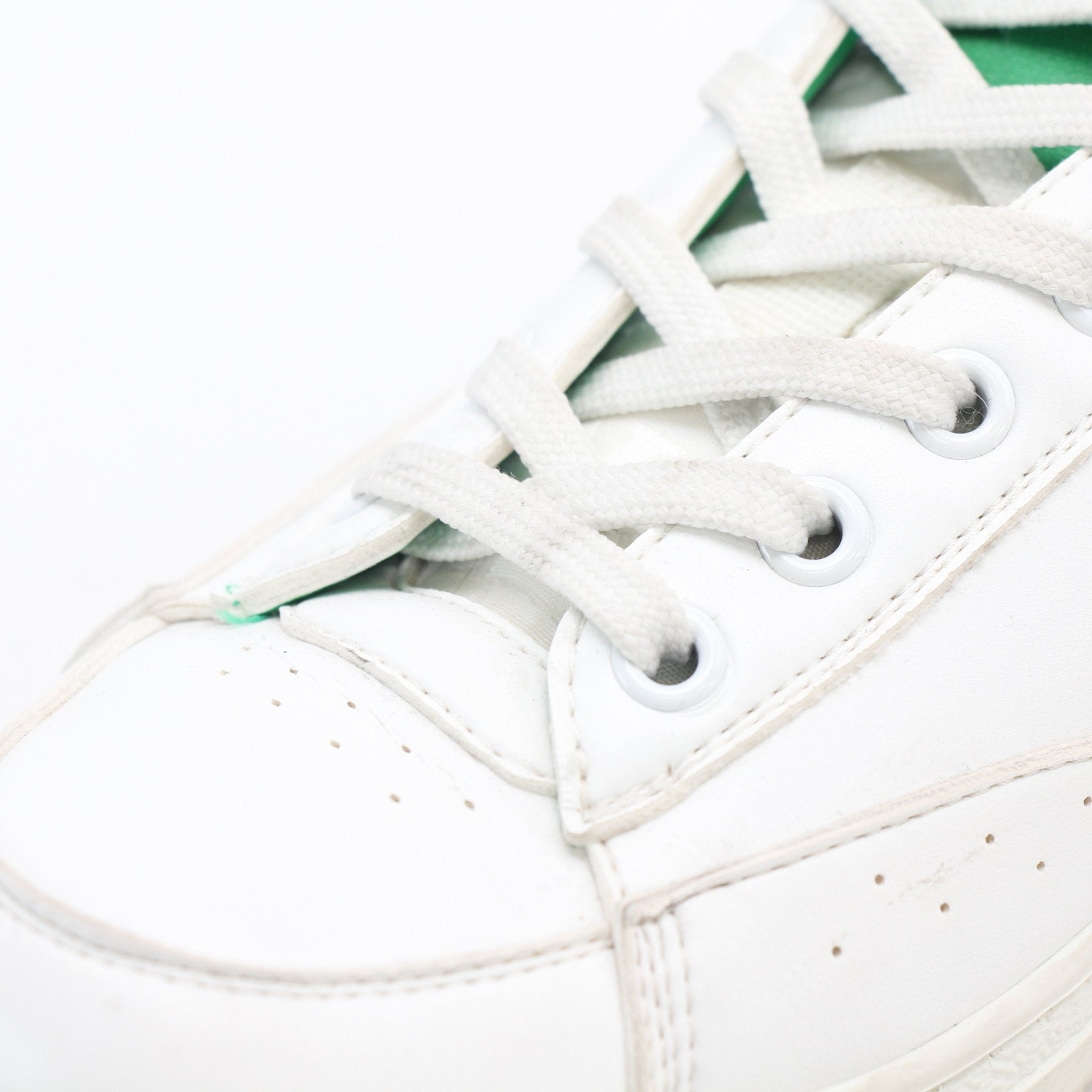 Louis Vuitton white and green Charlie low-top sneakers by Gold & Beyond, showcasing stylish leather shoes with logo details.