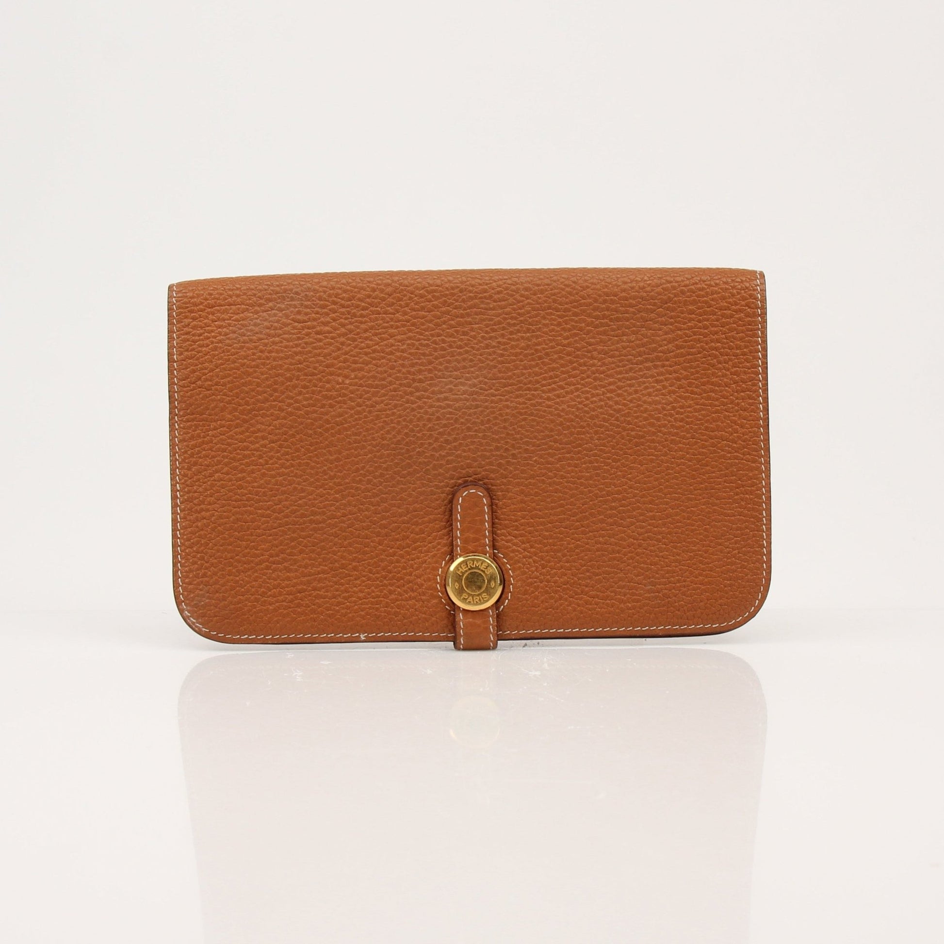 Hermès Brown Dogon Wallet by Gold & Beyond, showcasing a sleek leather wallet with gold hardware and compact design.